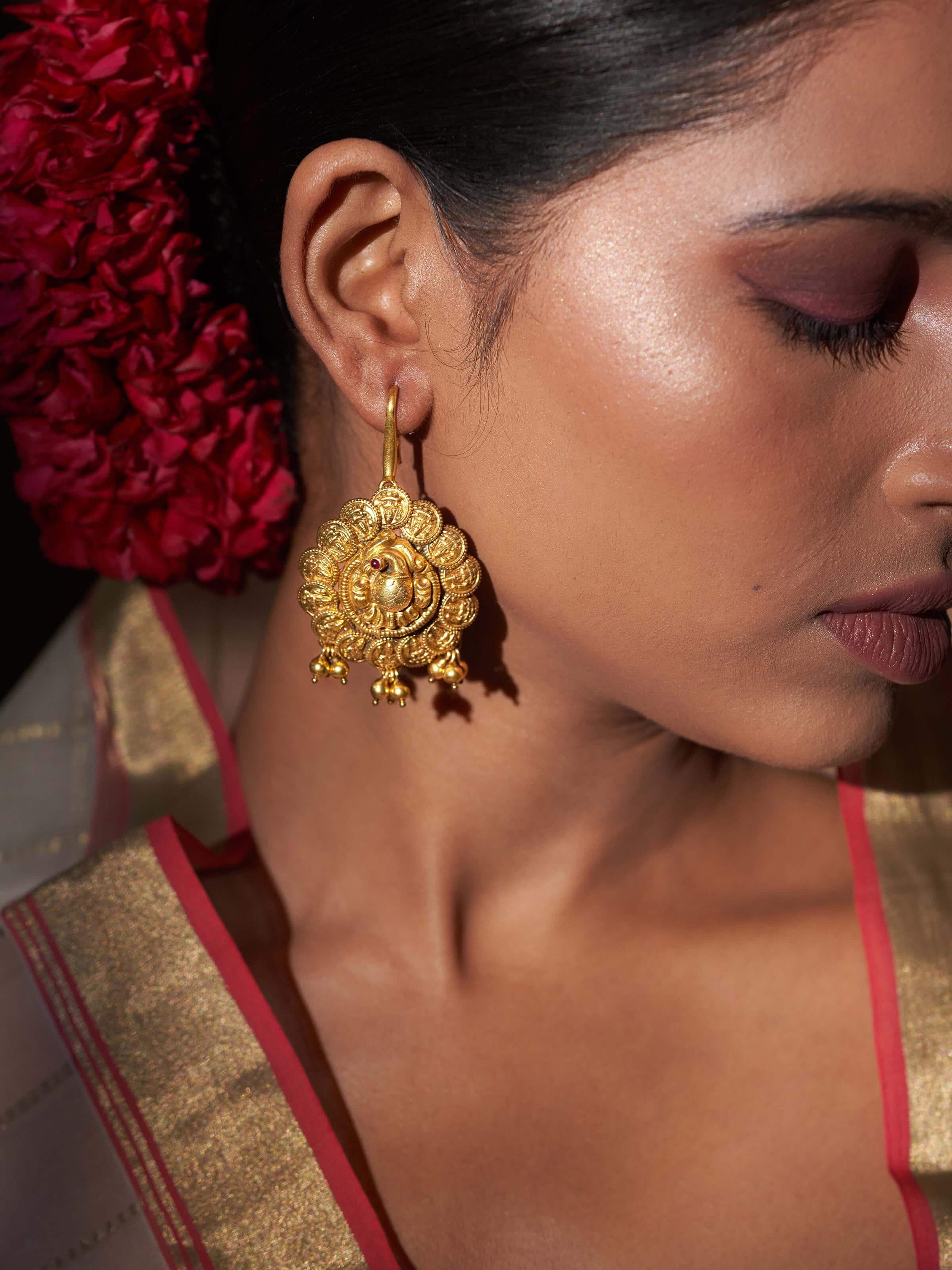 Close-up of Nakash Silver Jhumkas highlighting the intricate silver detailing and classic jhumka shape.