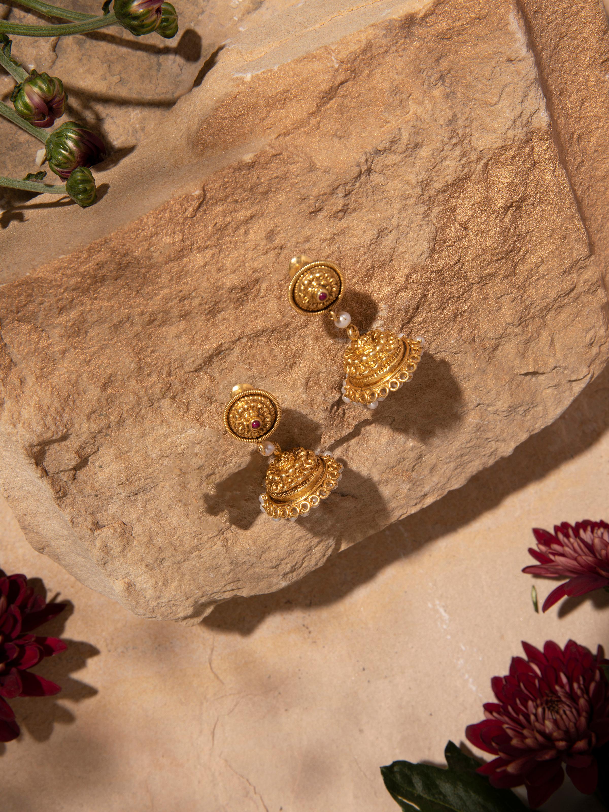 Close-up of Nakash silver jhumka earrings focusing on fine detailing and design