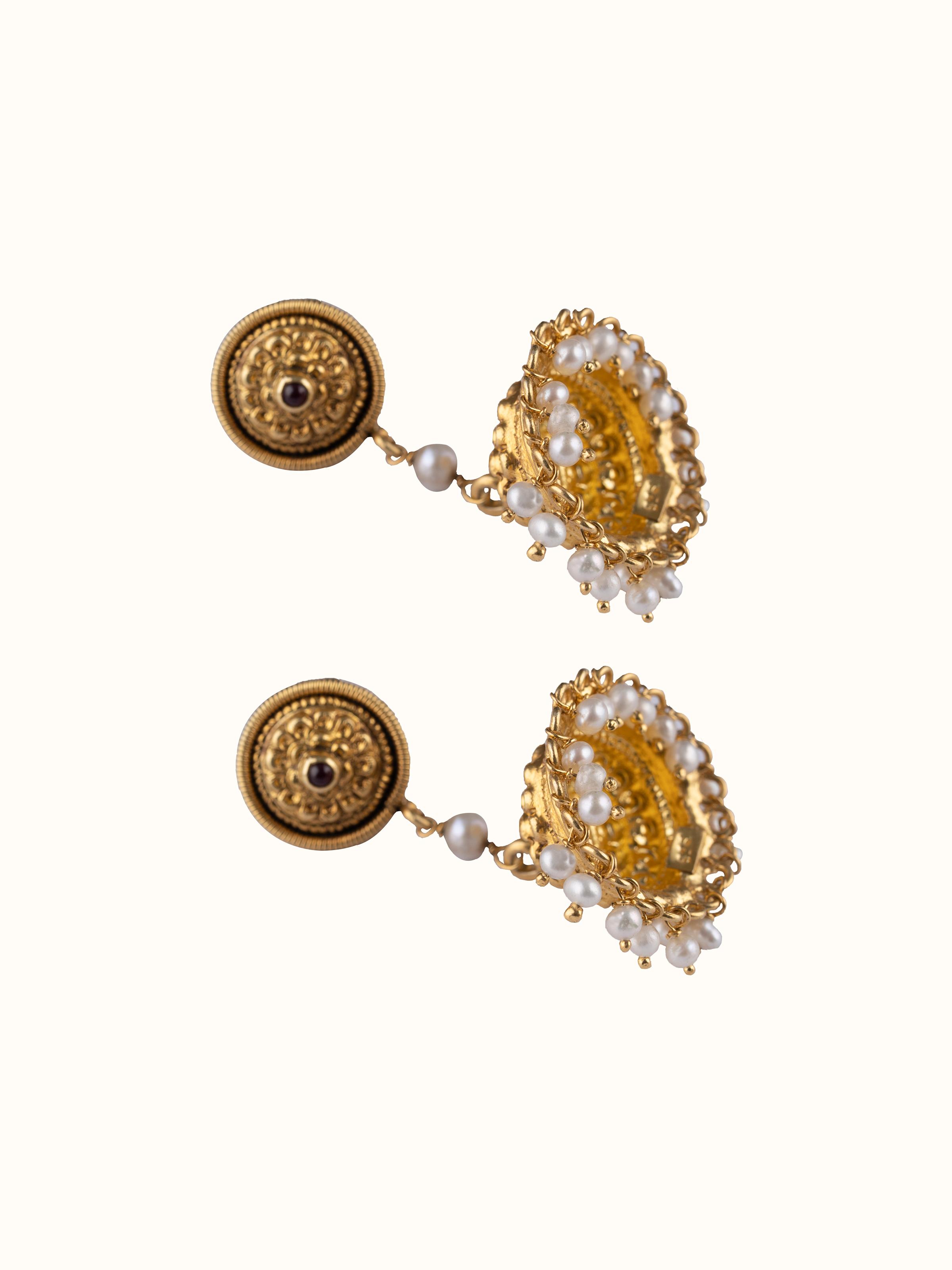 Overhead view of Nakash silver jhumka earrings displaying the complete design