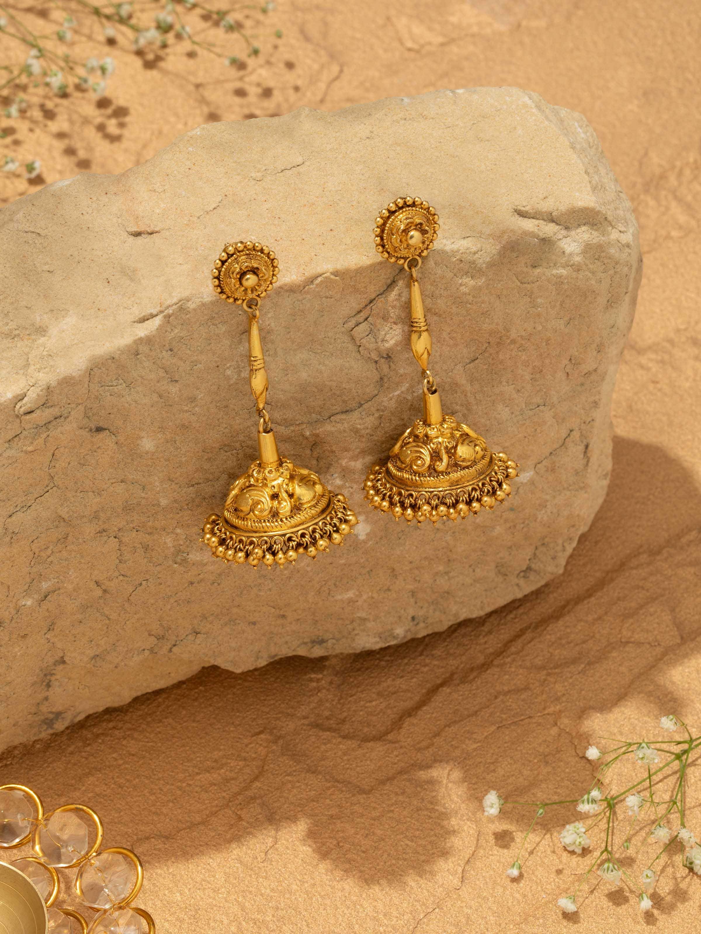 Overhead view of Nakash Silver Jhumkas emphasizing their drop design and intricate silver patterns.