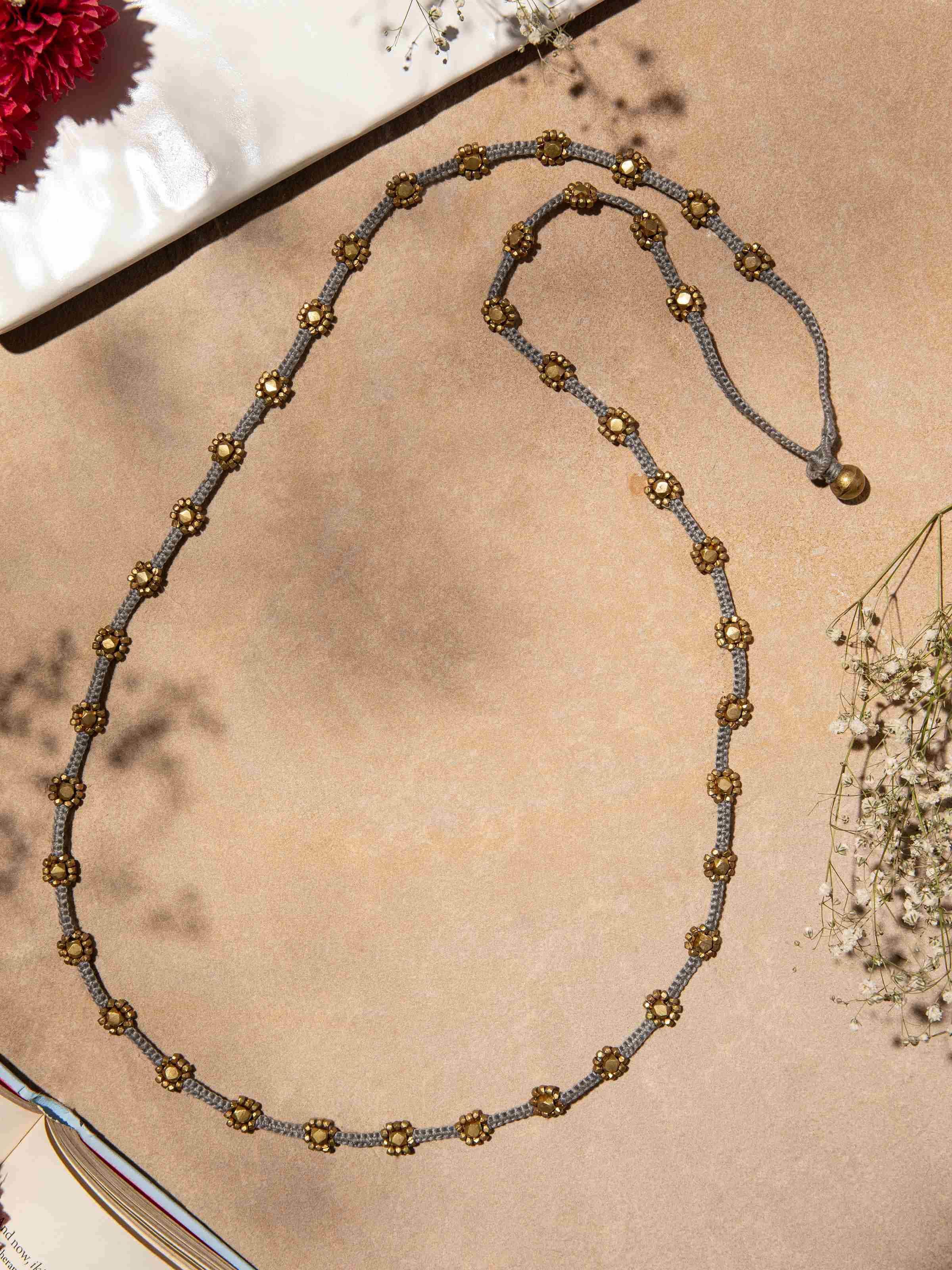 Side view of Dhokra Long Necklace highlighting the detailed Dhokra metalwork and design elements.