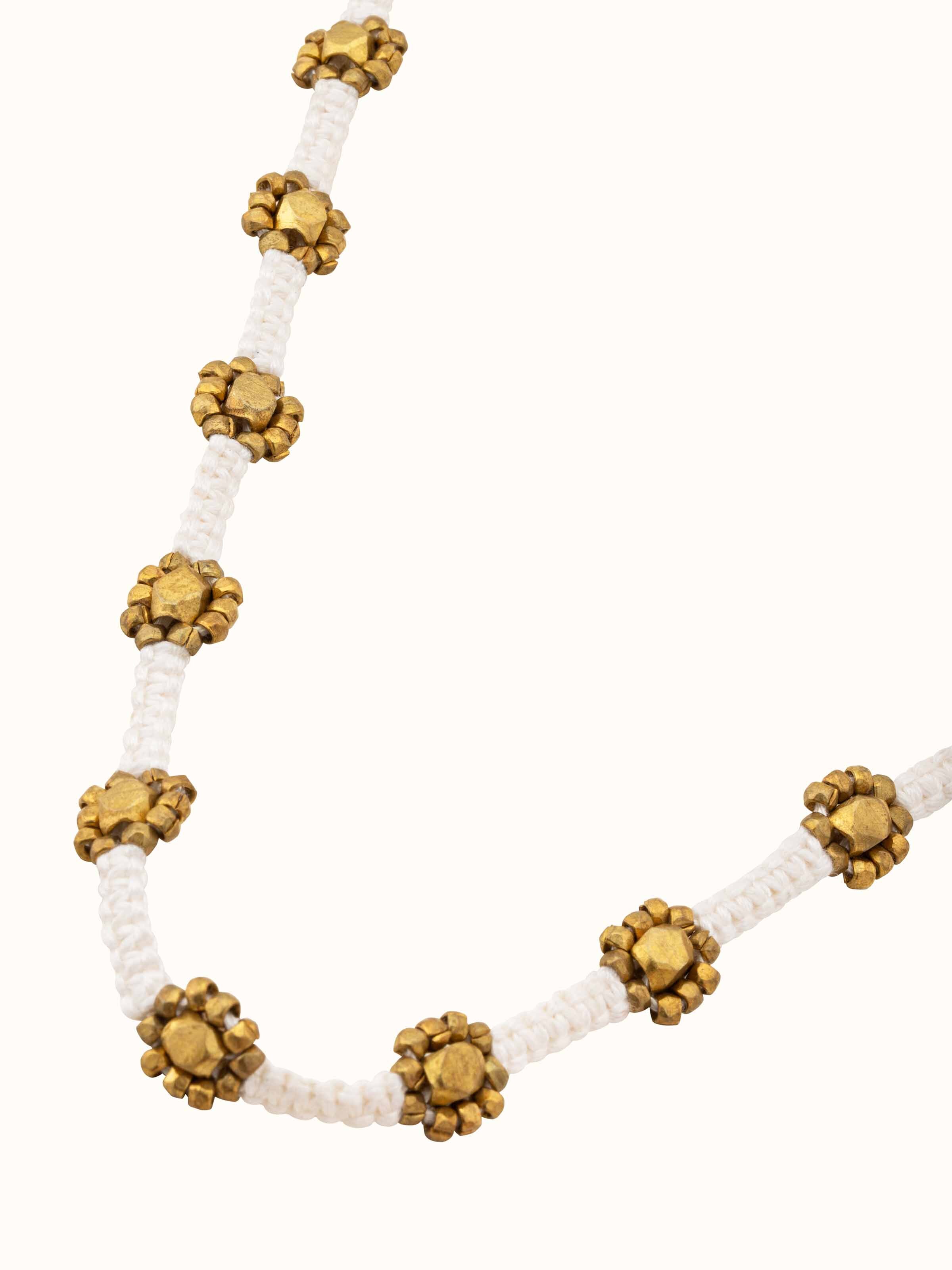 Angled view of Dhokra Long Necklace showcasing its unique patterns and craftsmanship.