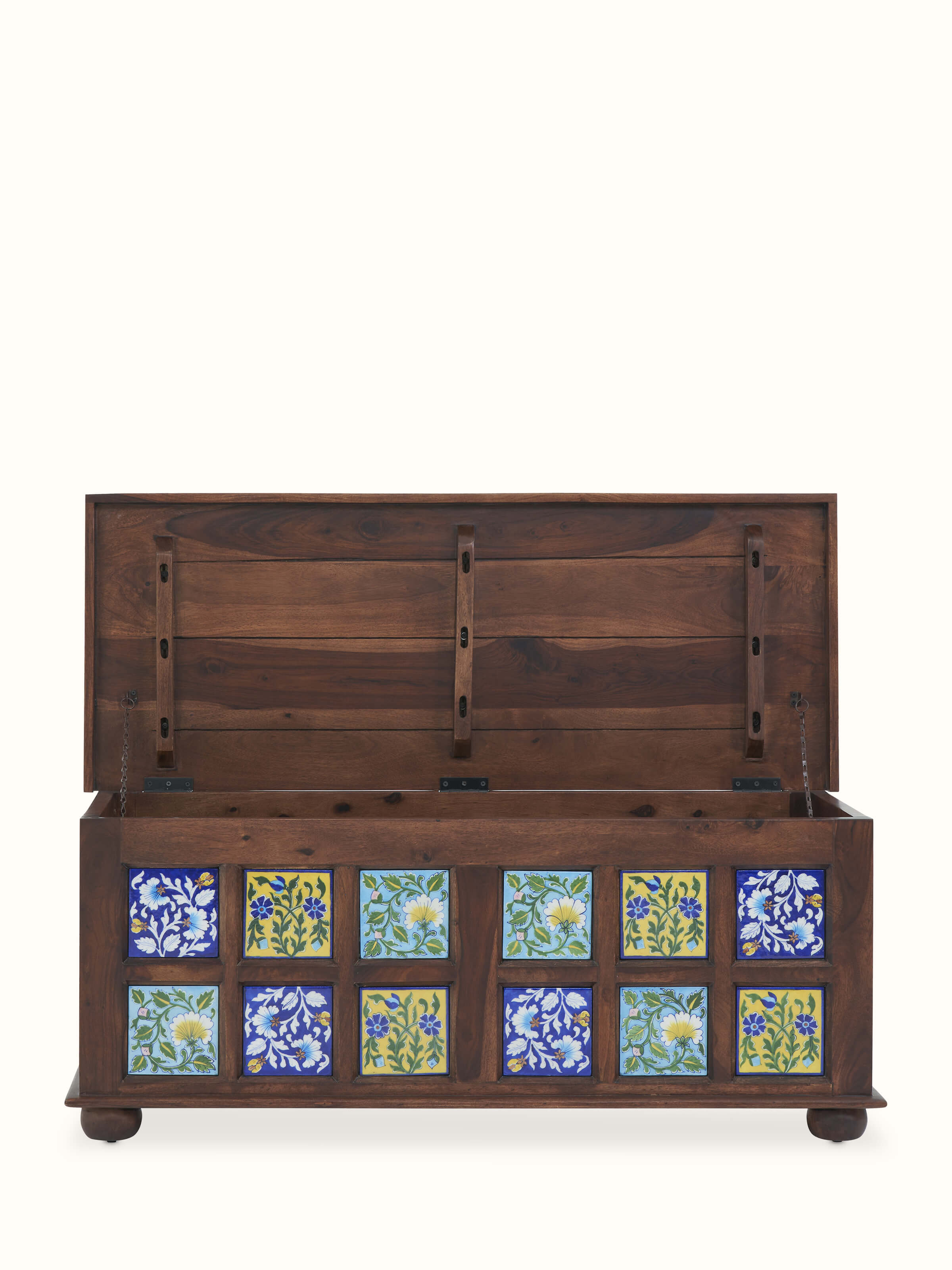 Sheesham wood trunk with blue pottery, showcasing the elegant design and intricate details that enhance its aesthetic appeal.