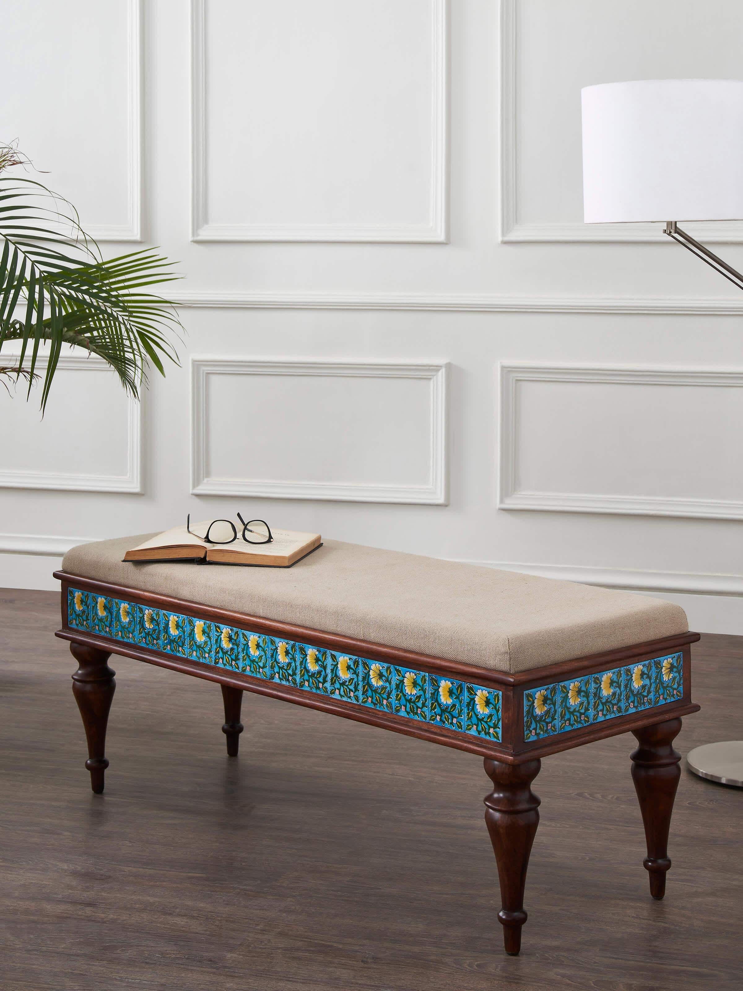 Side view of Sheesham wood blue pottery upholstered bench highlighting the unique blue pottery design and wood details