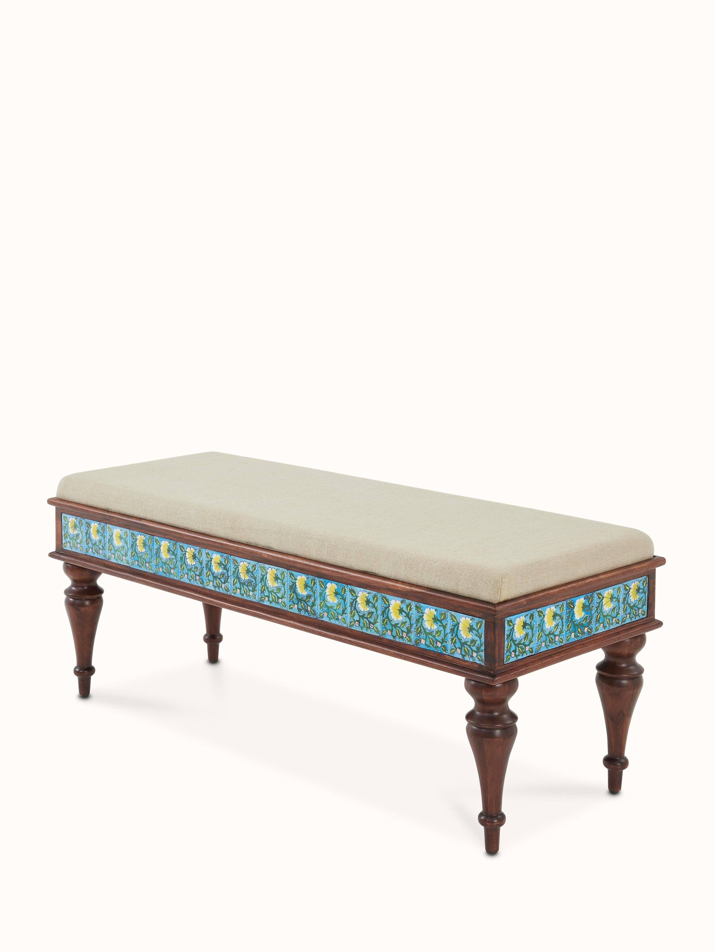 Angle view of Sheesham wood blue pottery upholstered bench, emphasizing the blend of traditional blue pottery and crafted wood