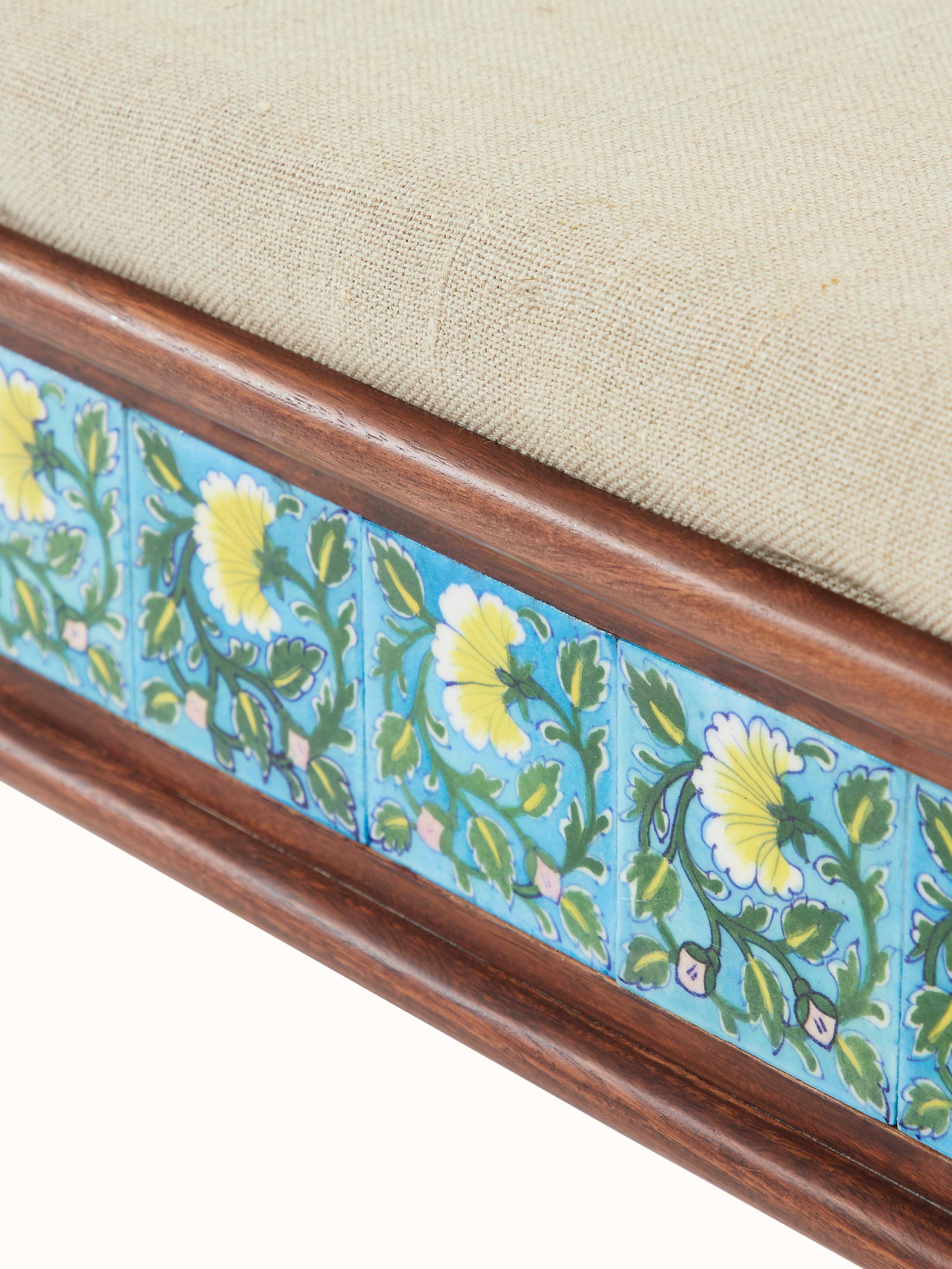 Close-up of Sheesham wood blue pottery upholstered bench’s blue pottery upholstery, showcasing the detailed craftsmanship