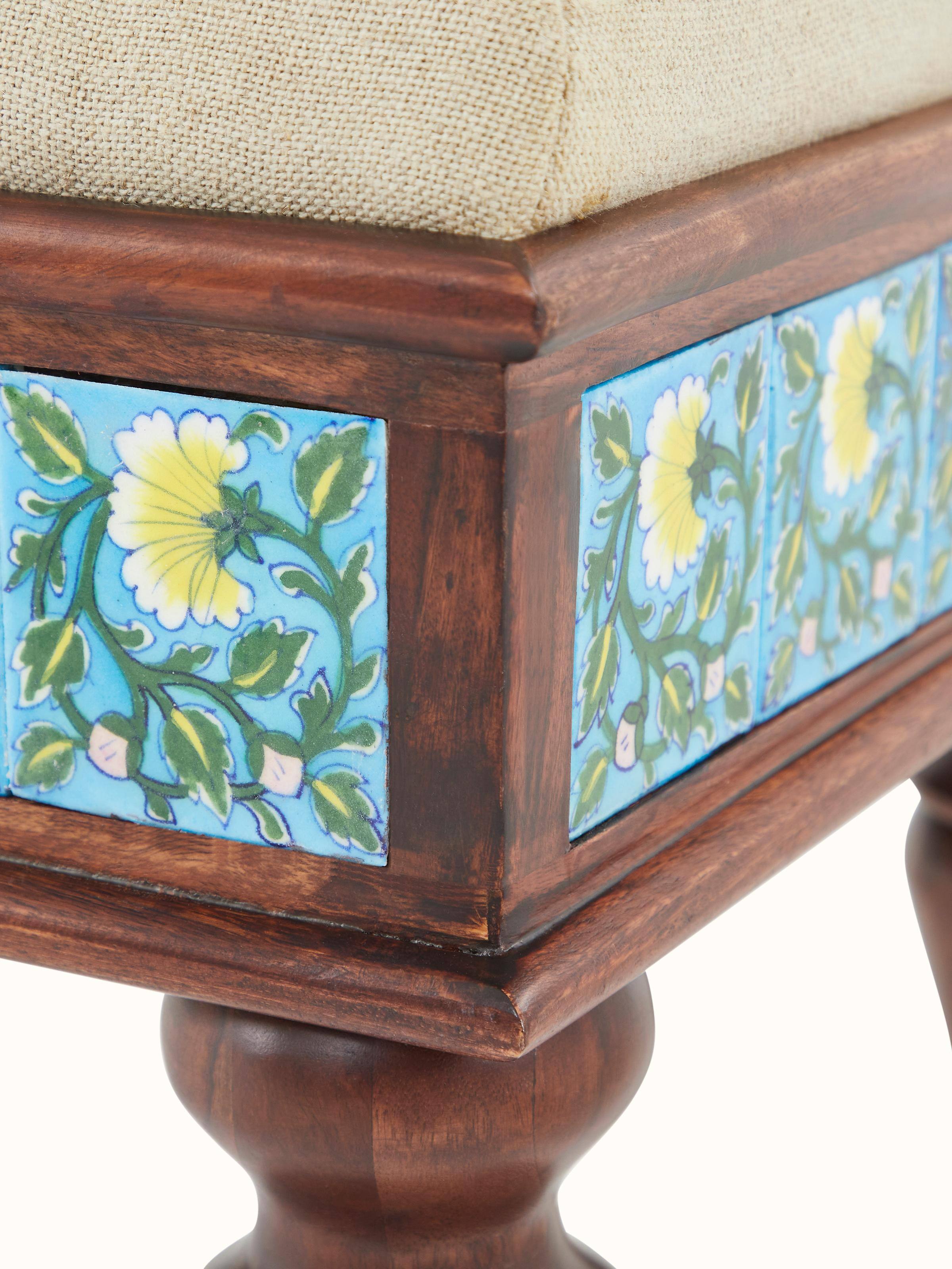 Detailed view of Sheesham wood frame and blue pottery upholstery on bench, highlighting the textures and patterns