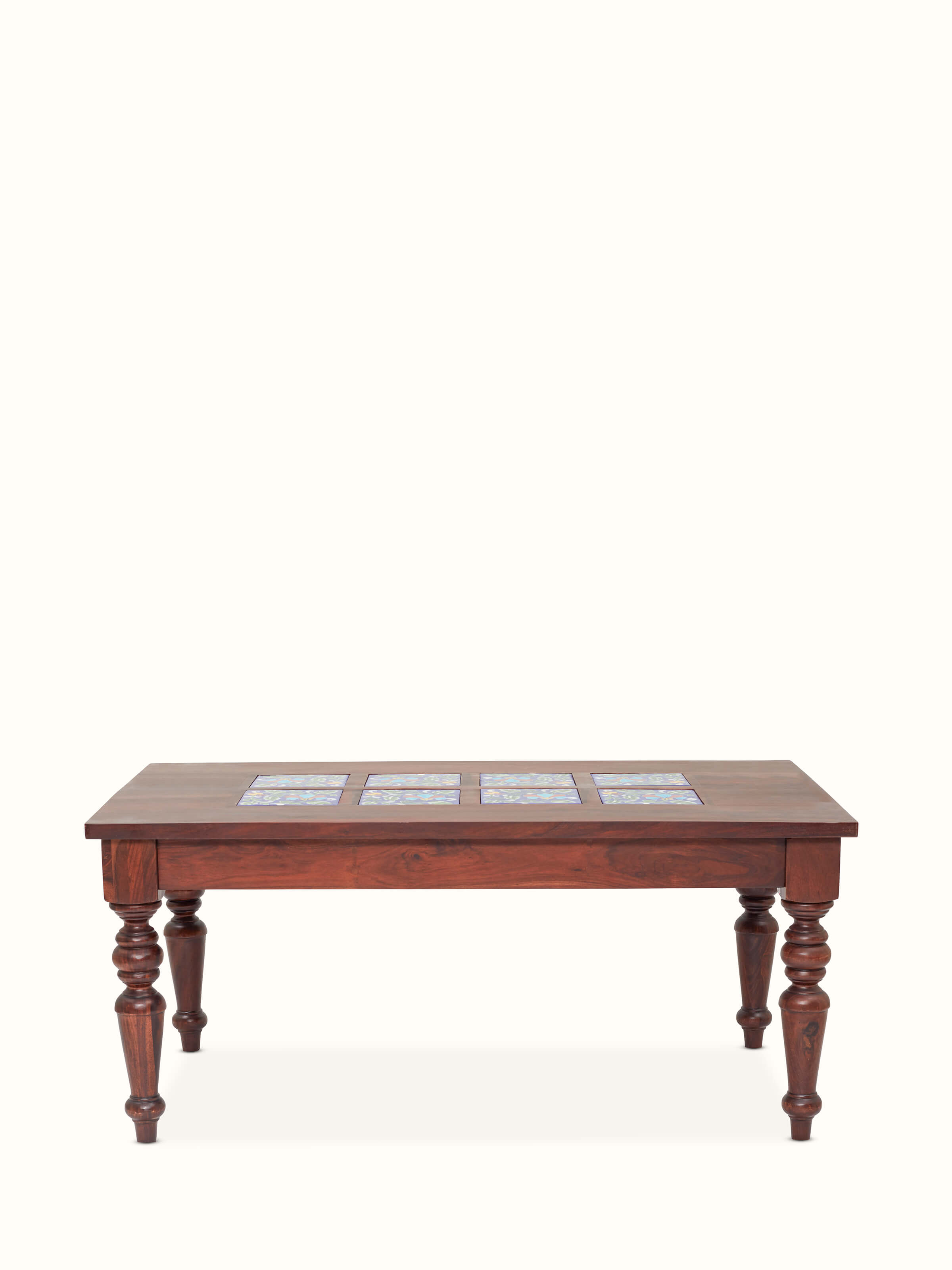 Front view of the Sheesham wood coffee table set with blue pottery, highlighting the set's craftsmanship and design.