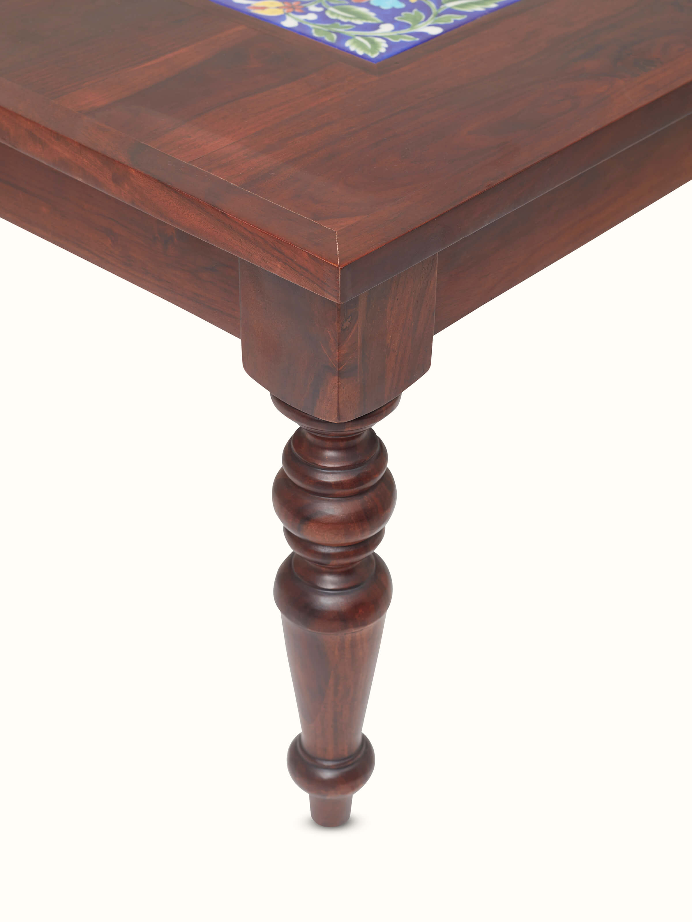 Close-up of the Sheesham wood coffee table set with blue pottery accents, showing the detailed finish and design.
