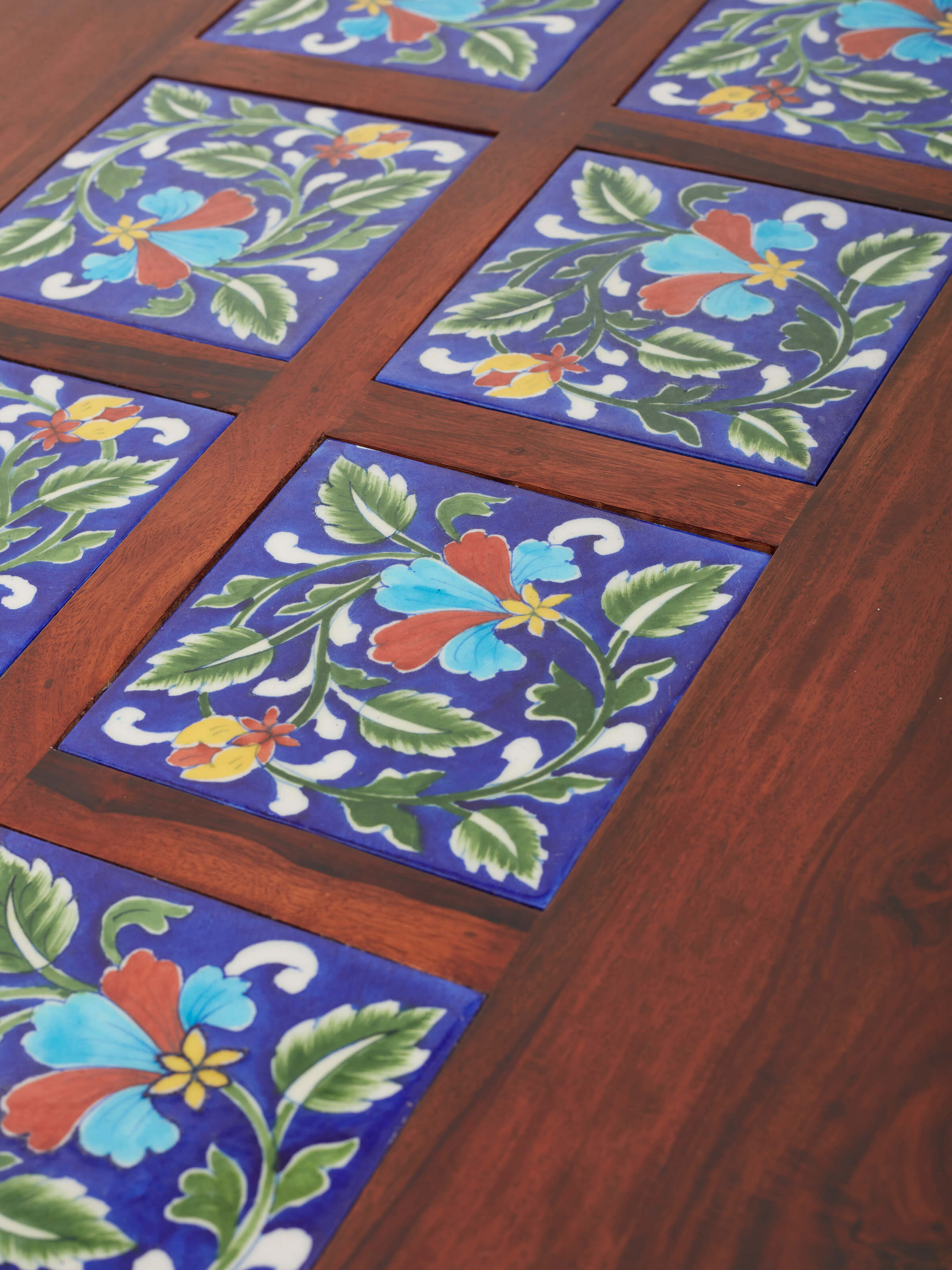 Full view of the three-piece coffee table set with Sheesham wood and blue pottery, showcasing the complete arrangement.