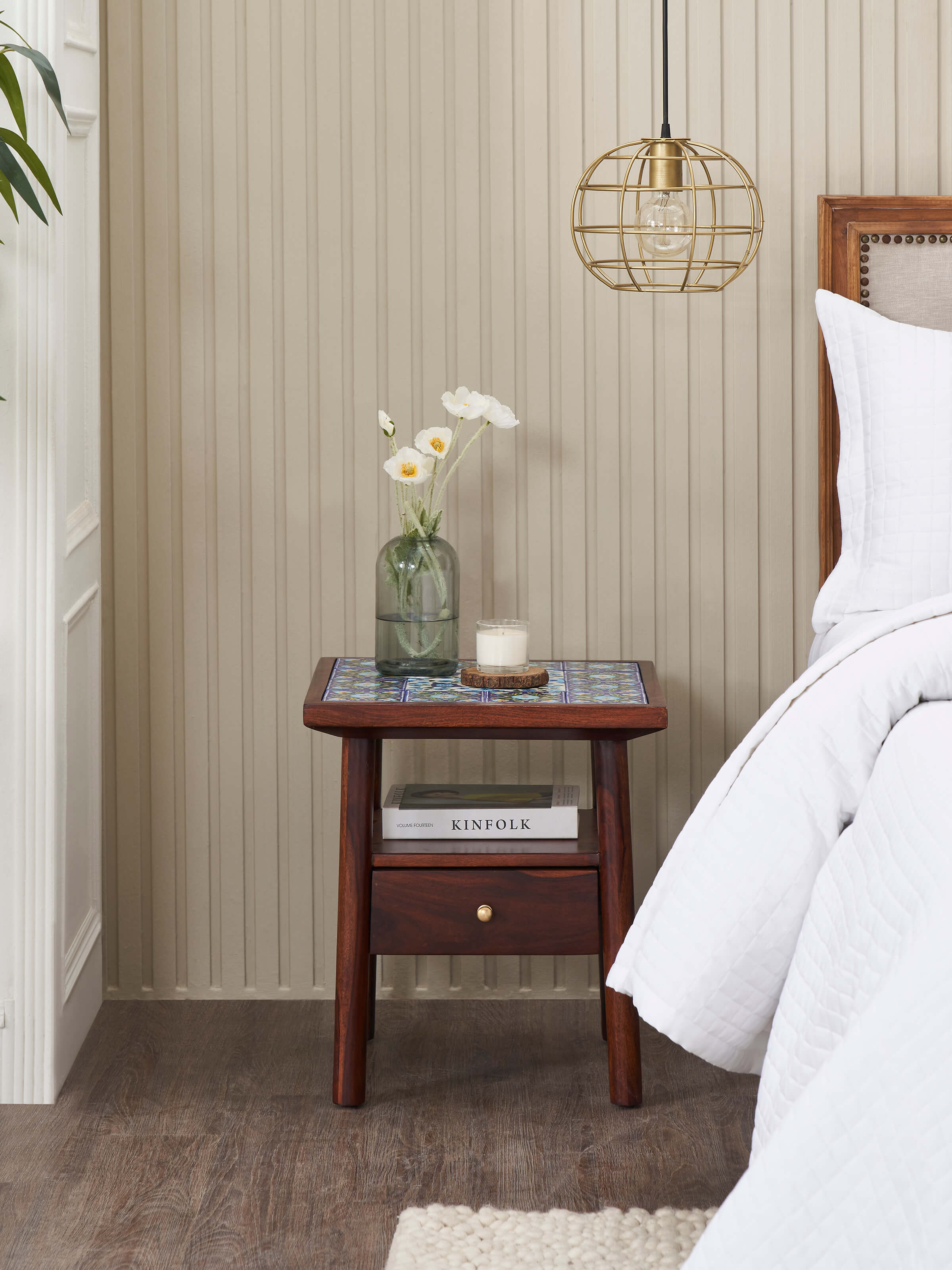 Side view of Sheesham wood side table featuring a blue pottery top, highlighting detailed floral patterns and sturdy build.
