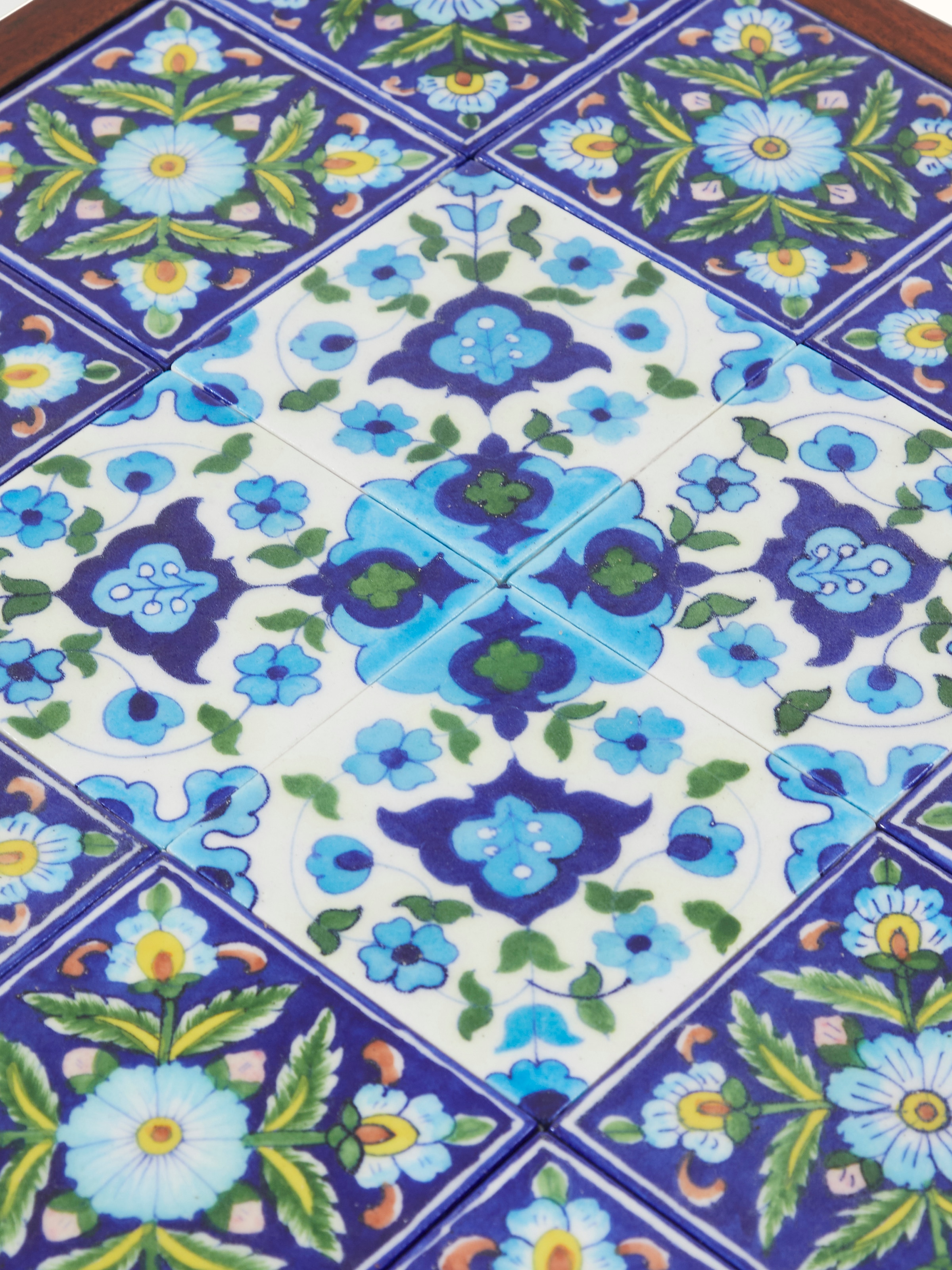 Back view of Sheesham wood side table with blue pottery top, revealing the structural design and craftsmanship.