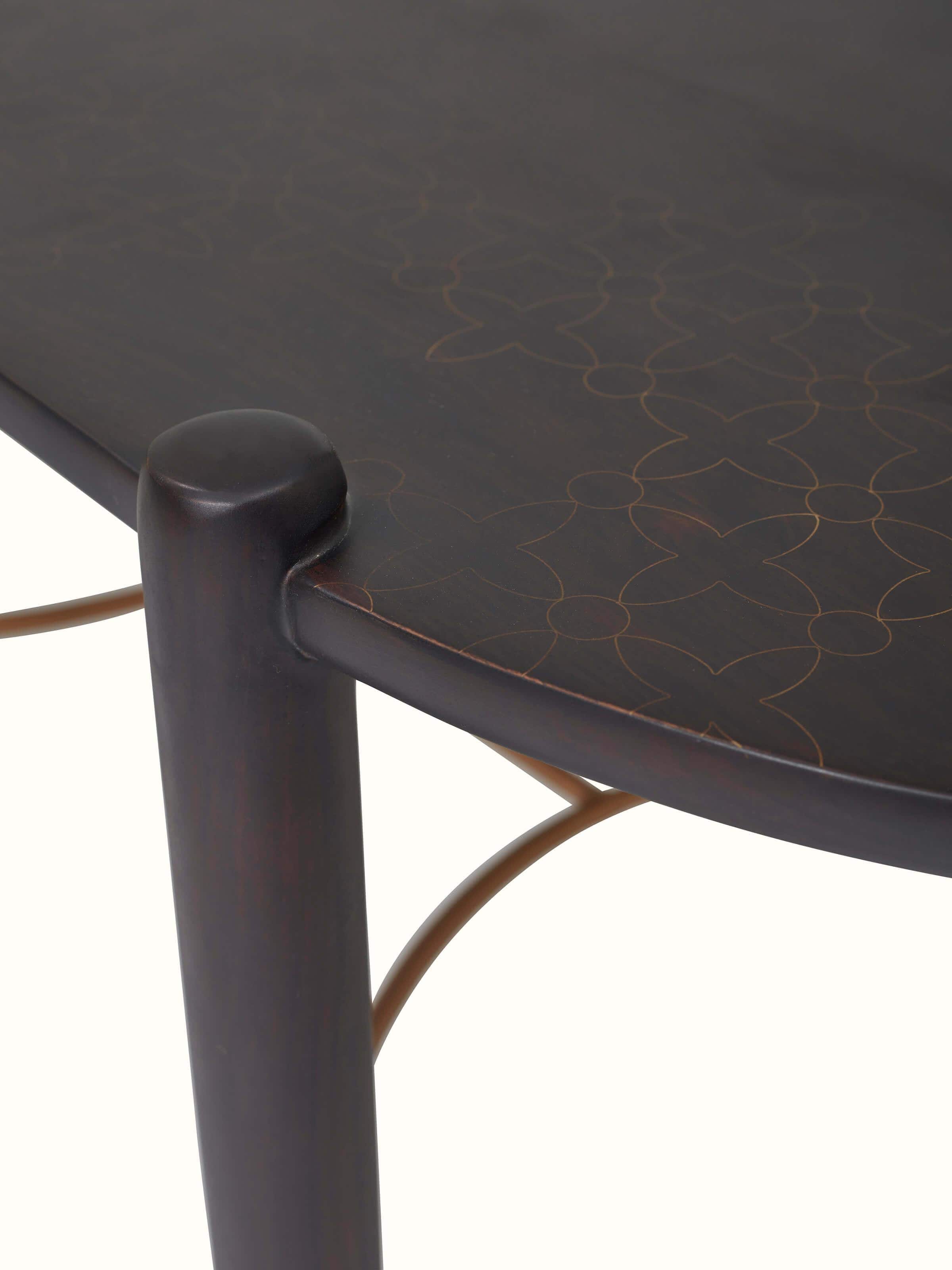 Detailed view of the brass tarkashi work on the Sheesham wood coffee table, highlighting the artistic inlay patterns.