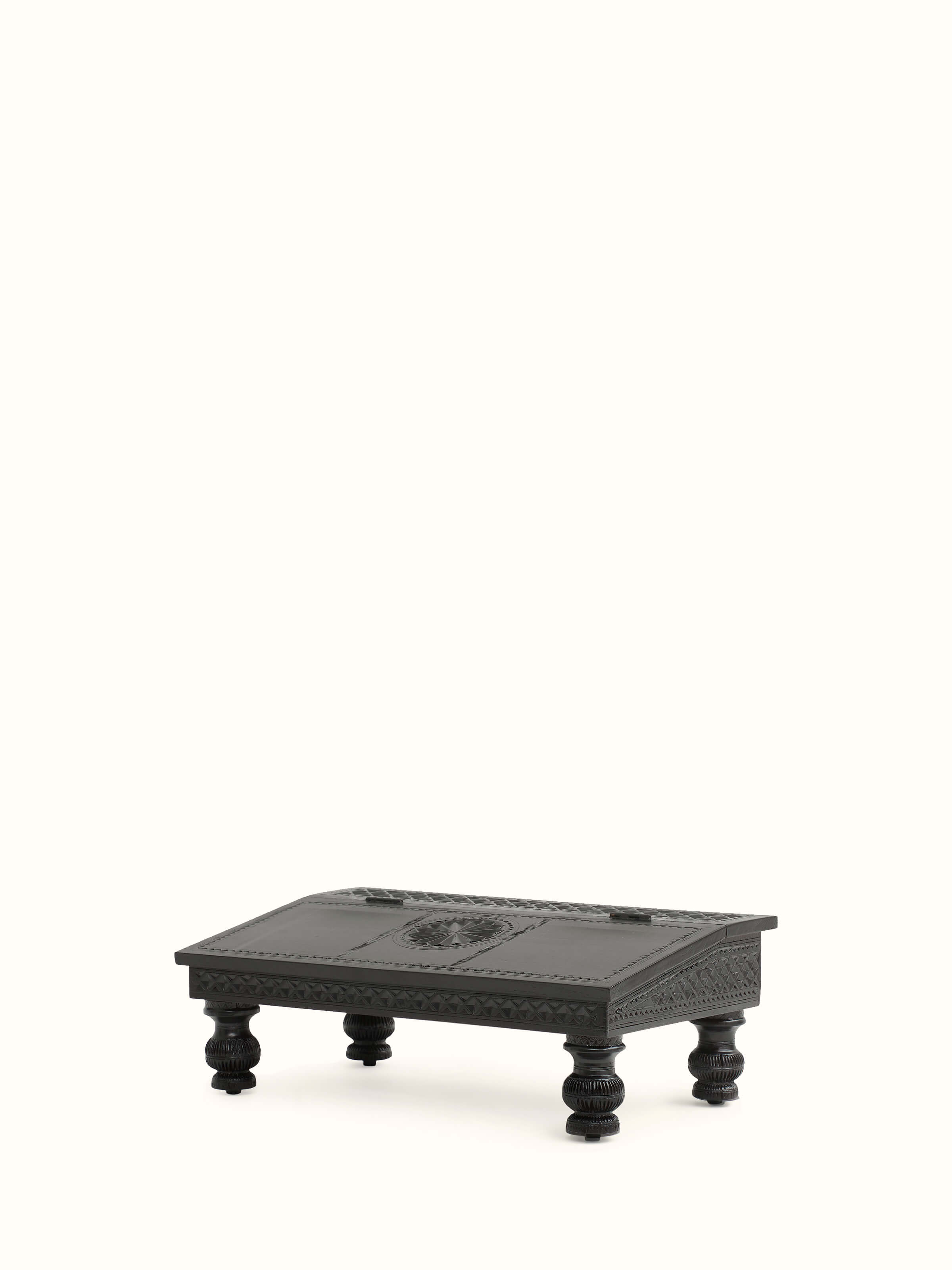 Close-up of the carved teak wood portable table, emphasizing the fine details and ornate carvings.