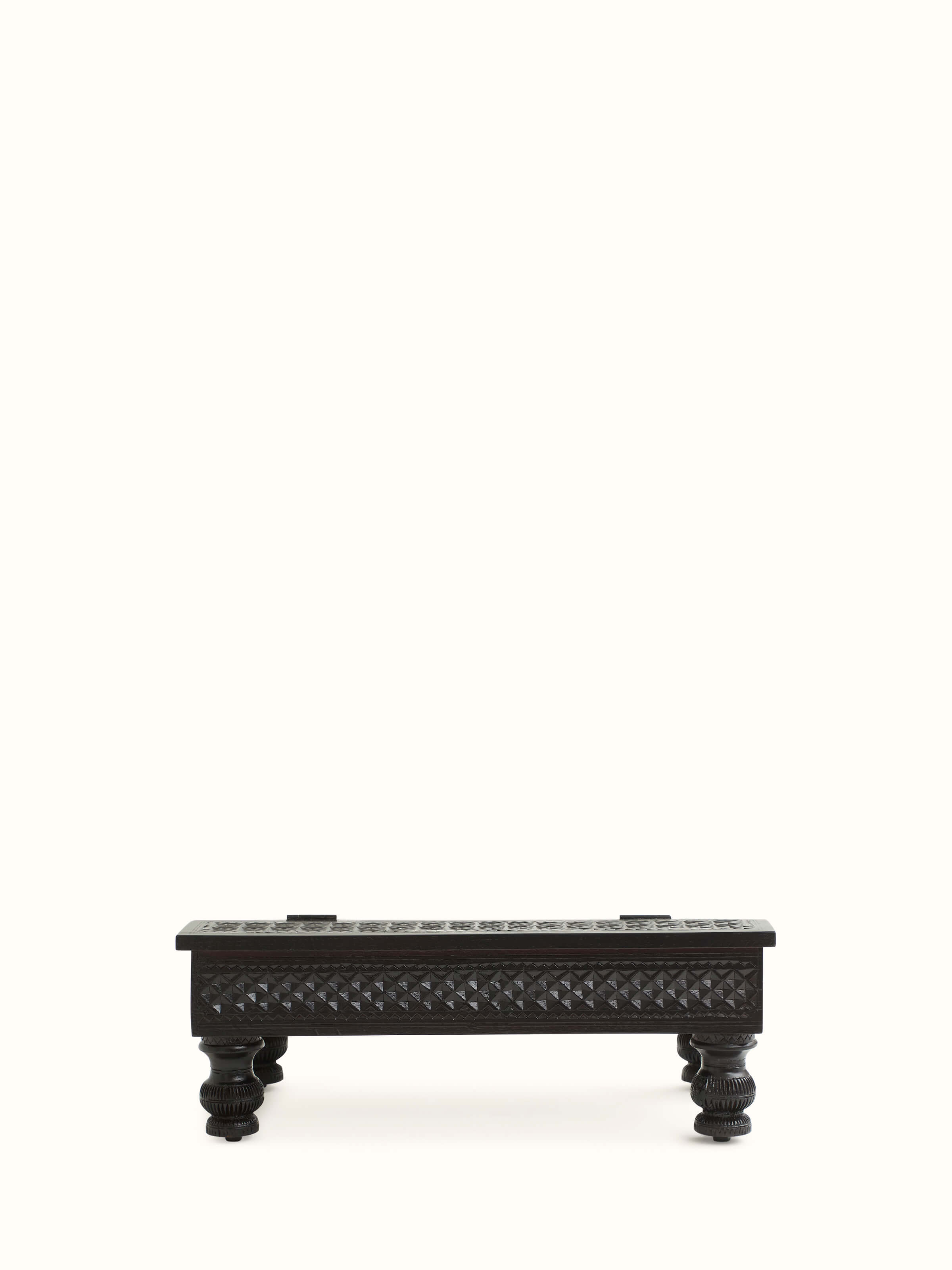 Close-up of the table’s surface and carvings, emphasizing the teak wood's natural beauty and artistry.