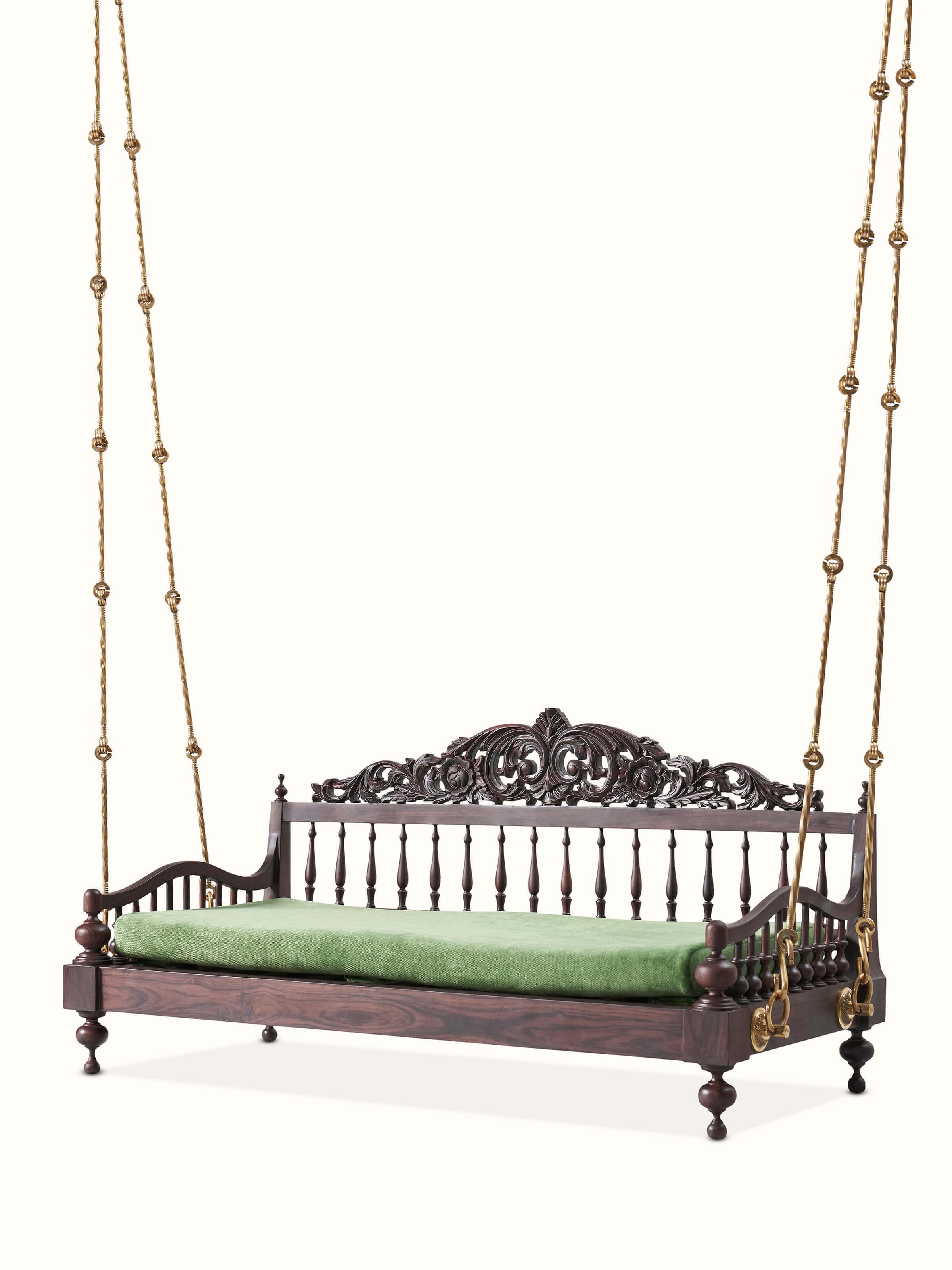 Side view of the rosewood swing highlighting the carved patterns and sturdy construction