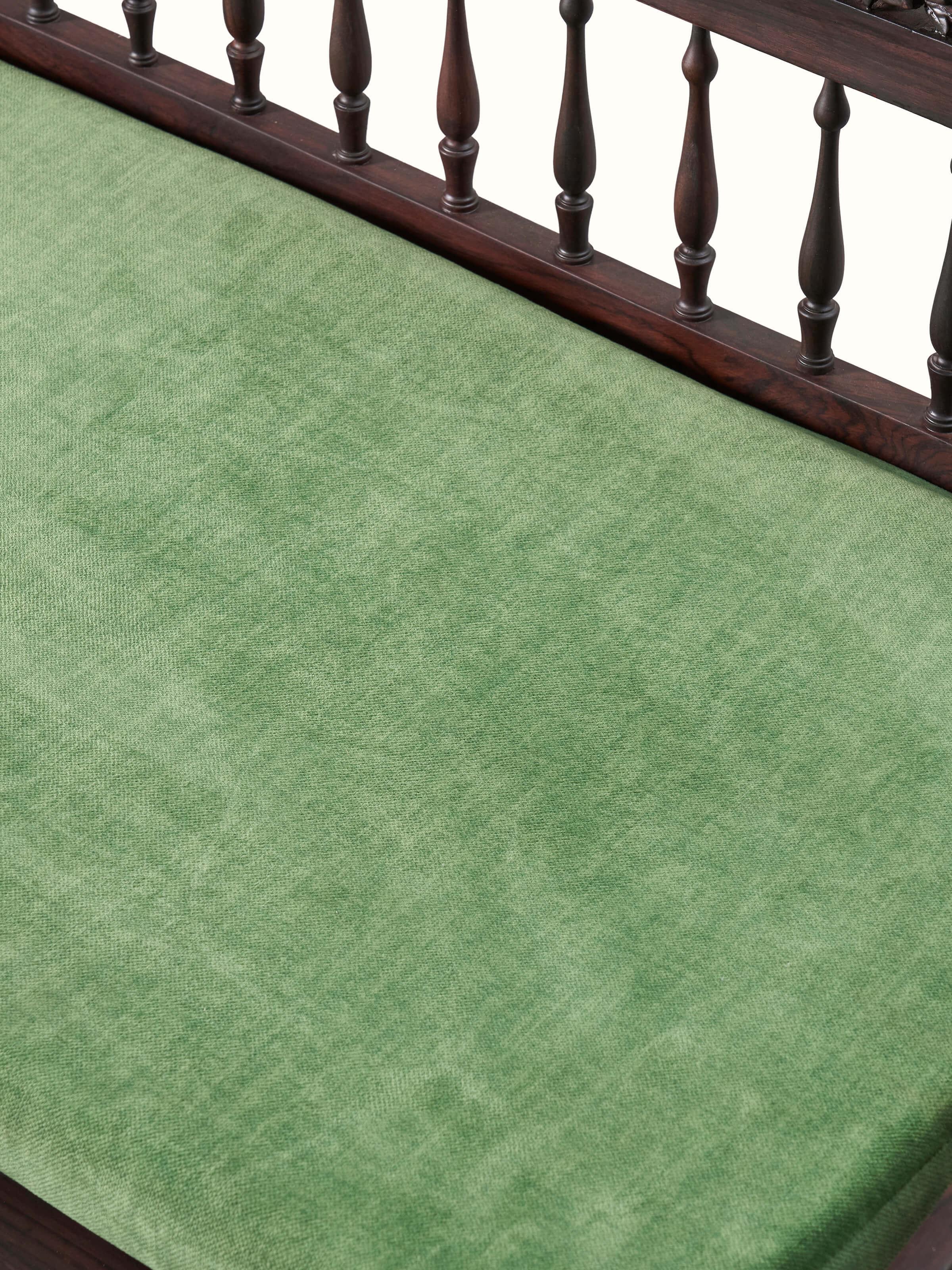 Close-up of the carved rosewood swing, focusing on the detailed woodwork and craftsmanship