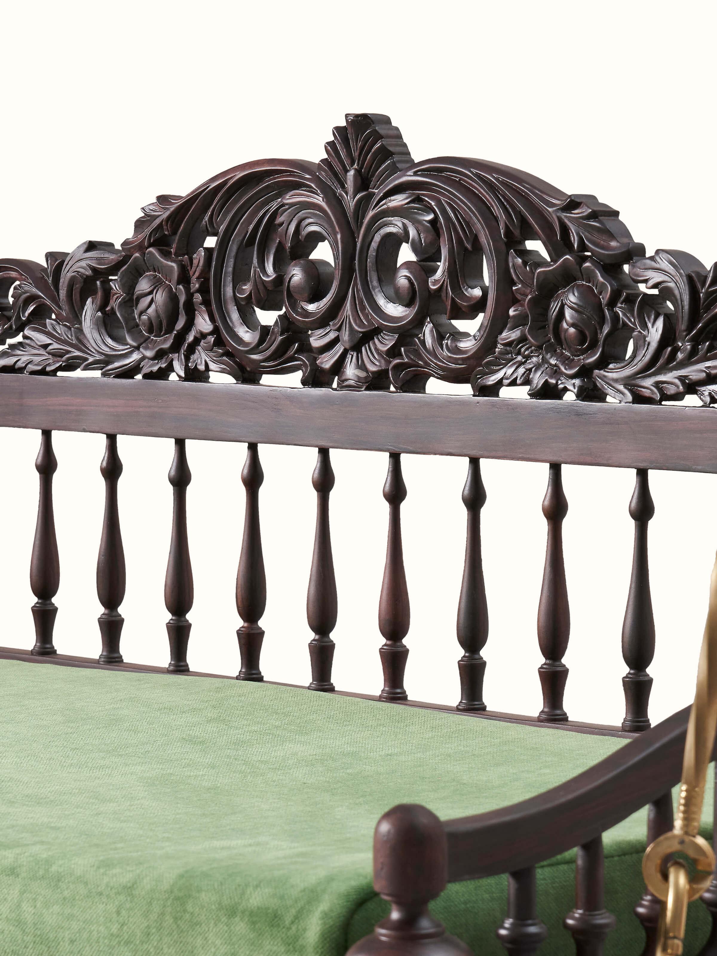 Angled view of the rosewood swing, showcasing its design and decorative elements from a different perspective