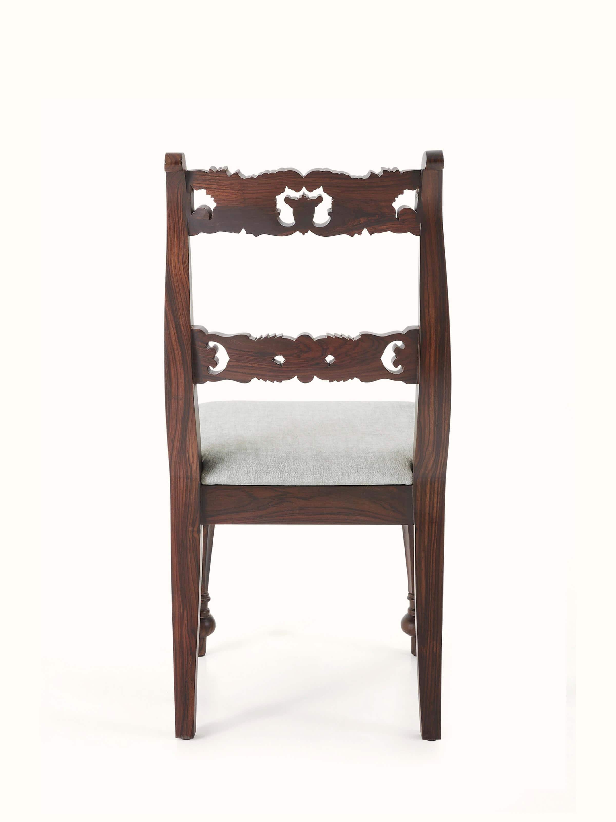 Full view of upholstered carved rosewood dining chair, presenting its traditional design and luxurious upholstery.