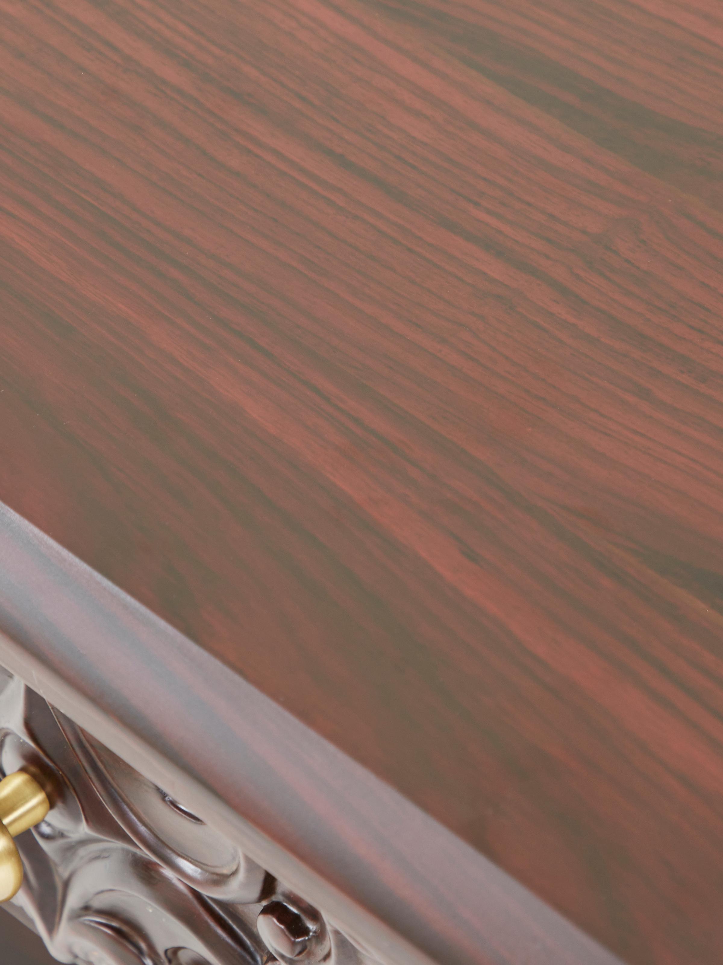 Close-up of the carvings on the rosewood bedside table, showcasing the fine craftsmanship and details.
