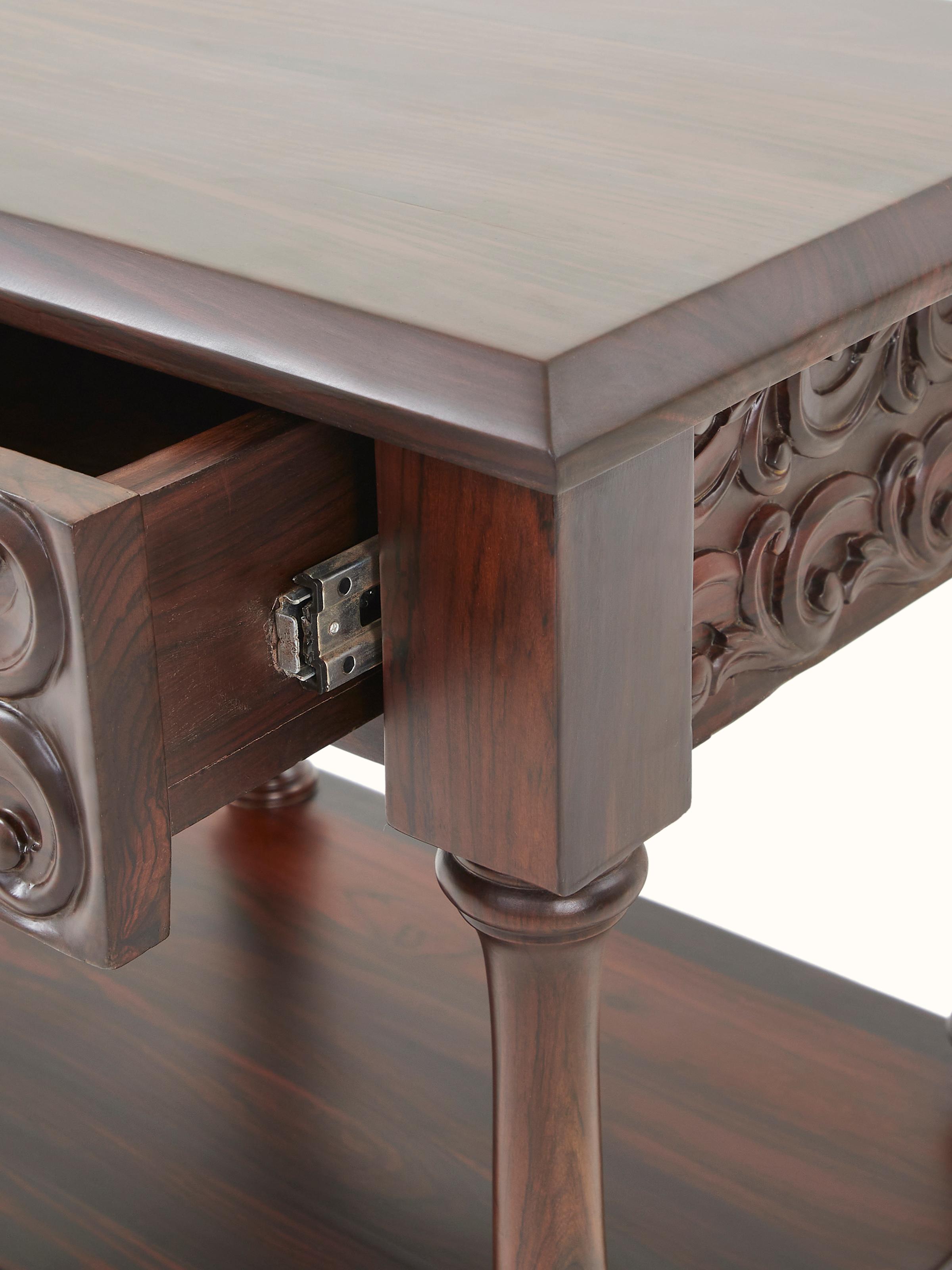 Front view showing the carved rosewood bedside table with its elegant legs and detailed work.