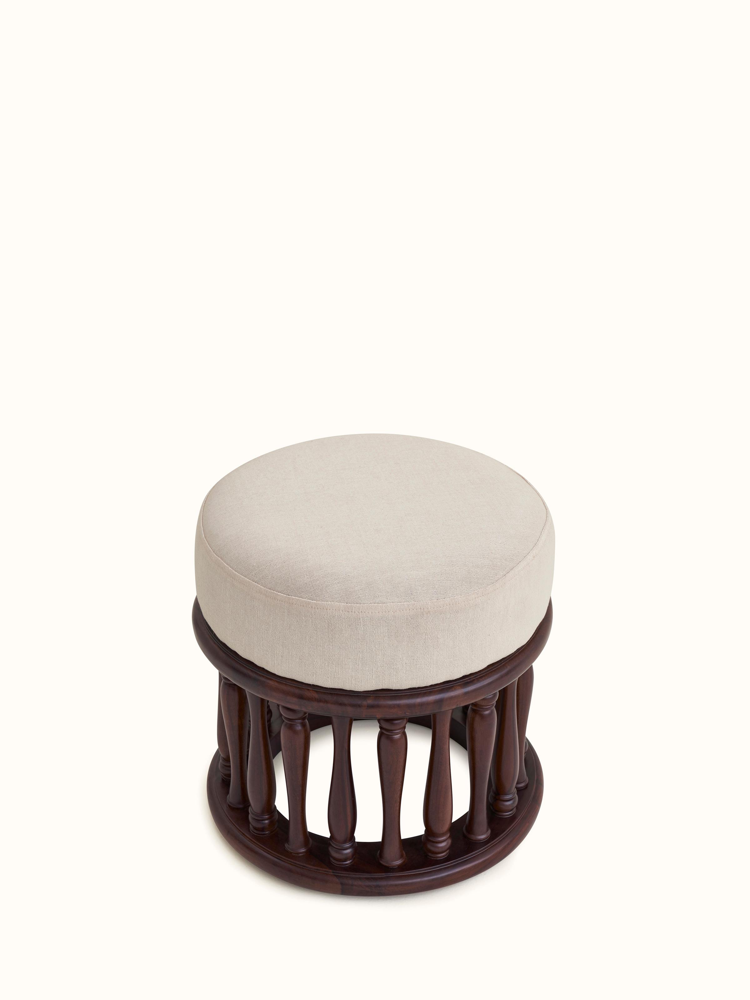 Close-up of upholstered Sheesham wood round pouffe, showcasing the detailed stitching and texture of the fabric