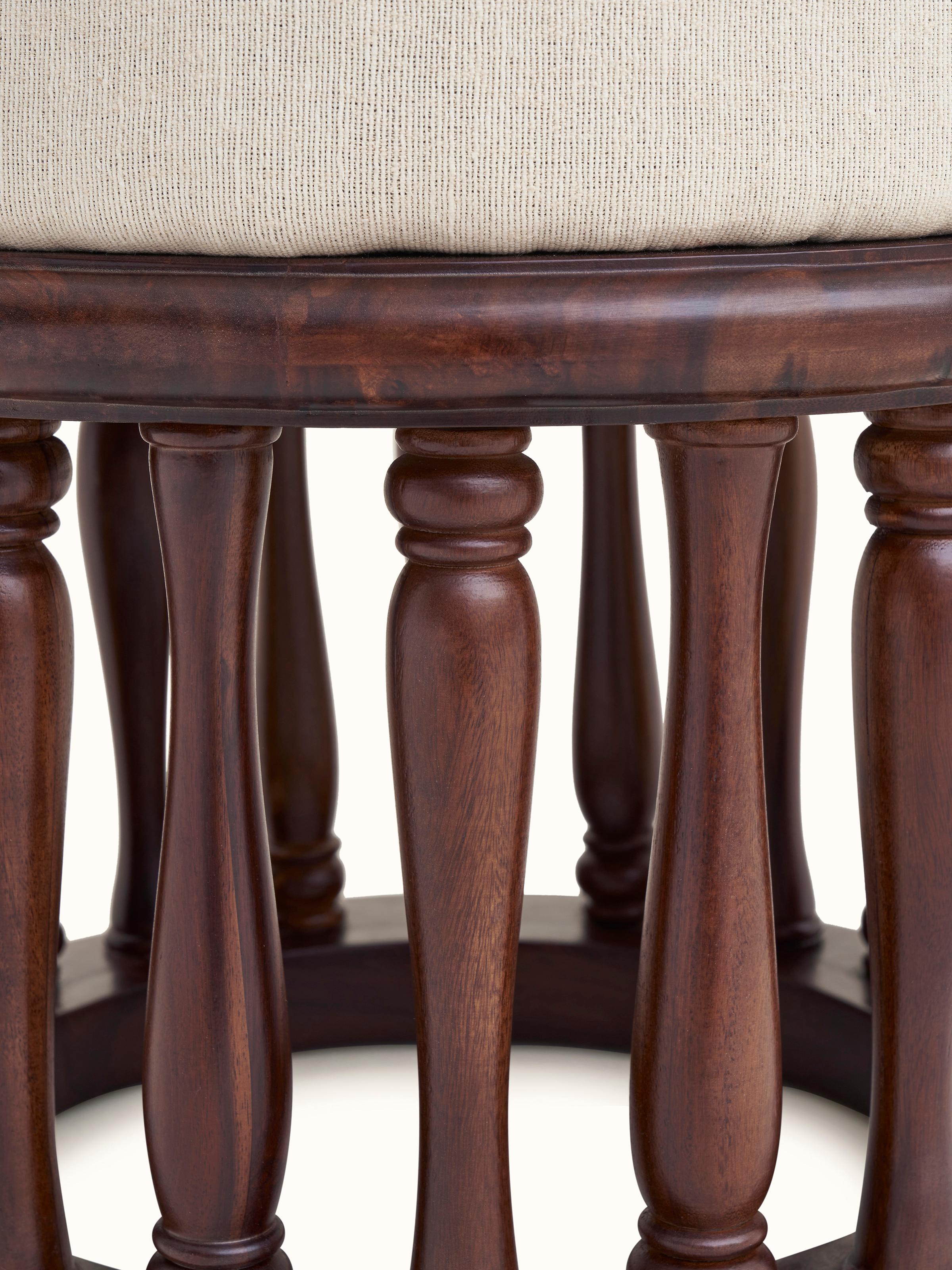 Angled view of upholstered Sheesham wood round pouffe, displaying the full shape and the quality of the materials used