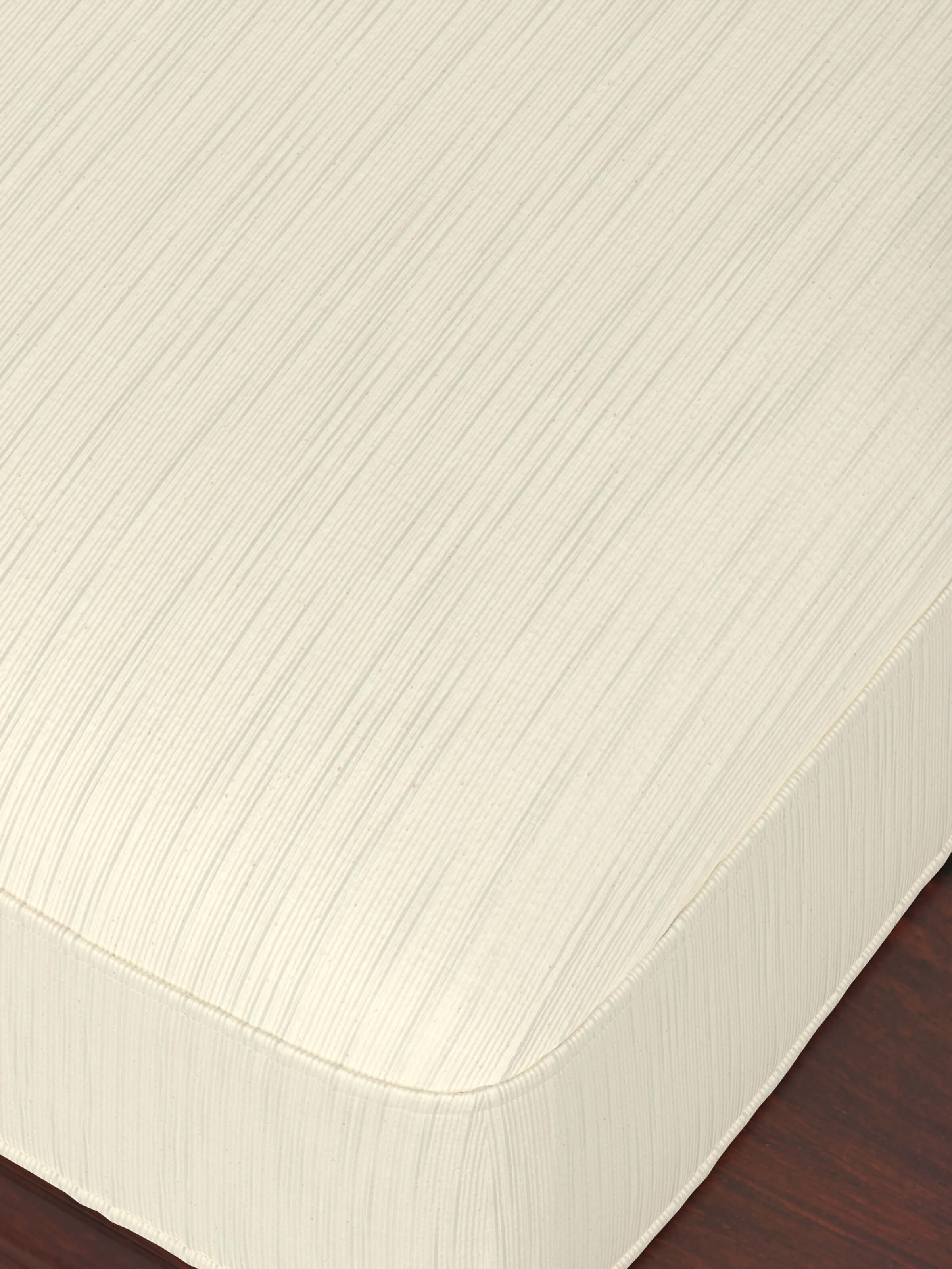Close-up view of the upholstery and wood frame of the teak finish Sheesham wood daybed.