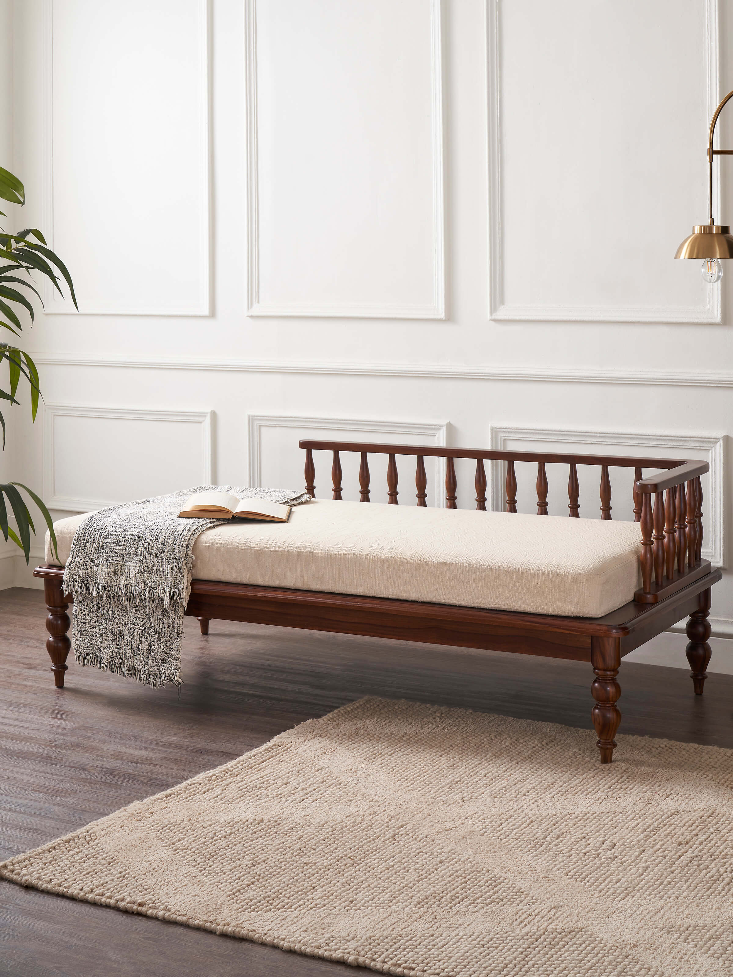 Side view of Teak finish upholstered Sheesham wood daybed highlighting the wood grain and luxurious upholstery