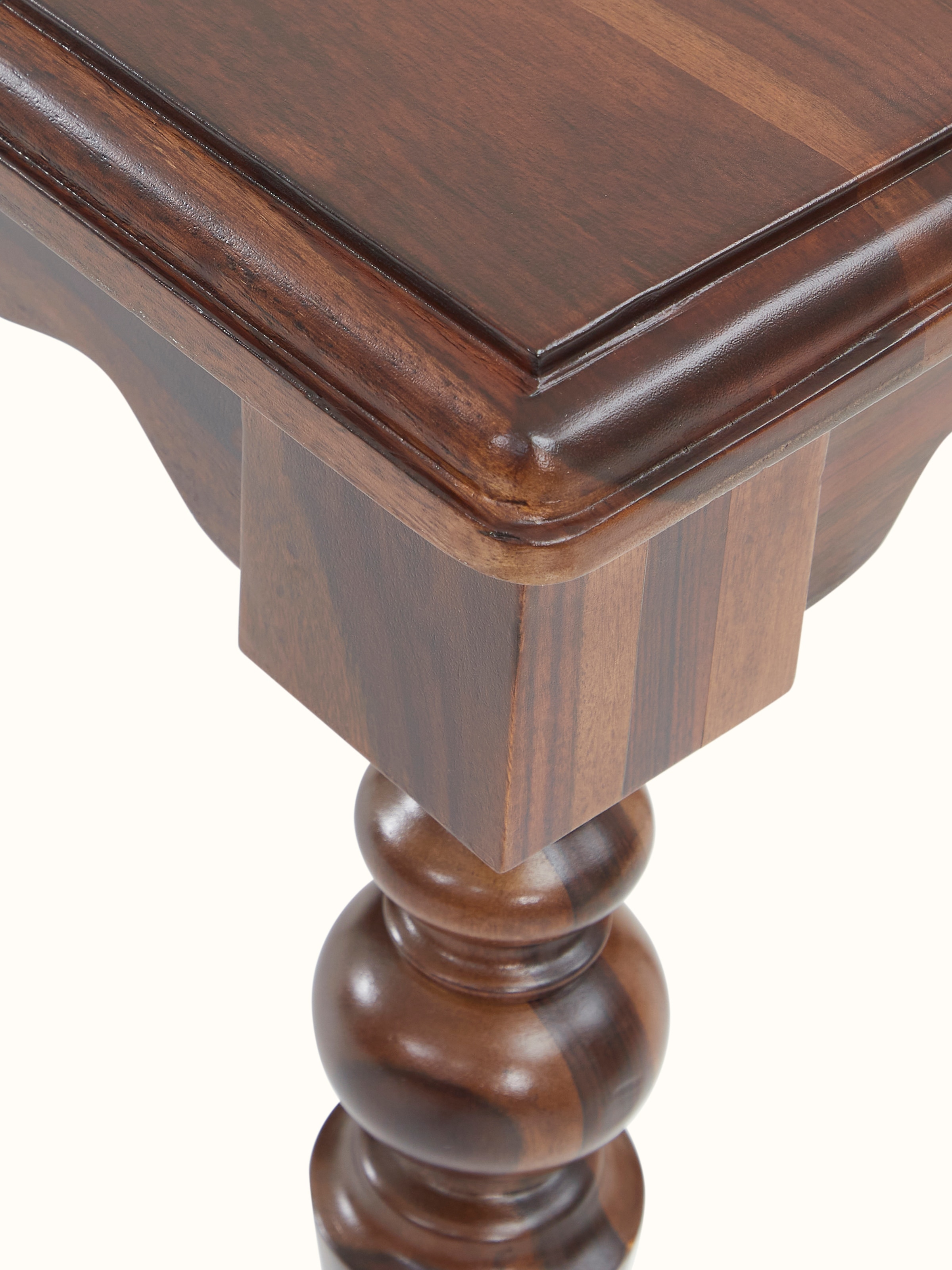 Angled view of the Sheesham wood bench, showing the bench’s profile and structural details.