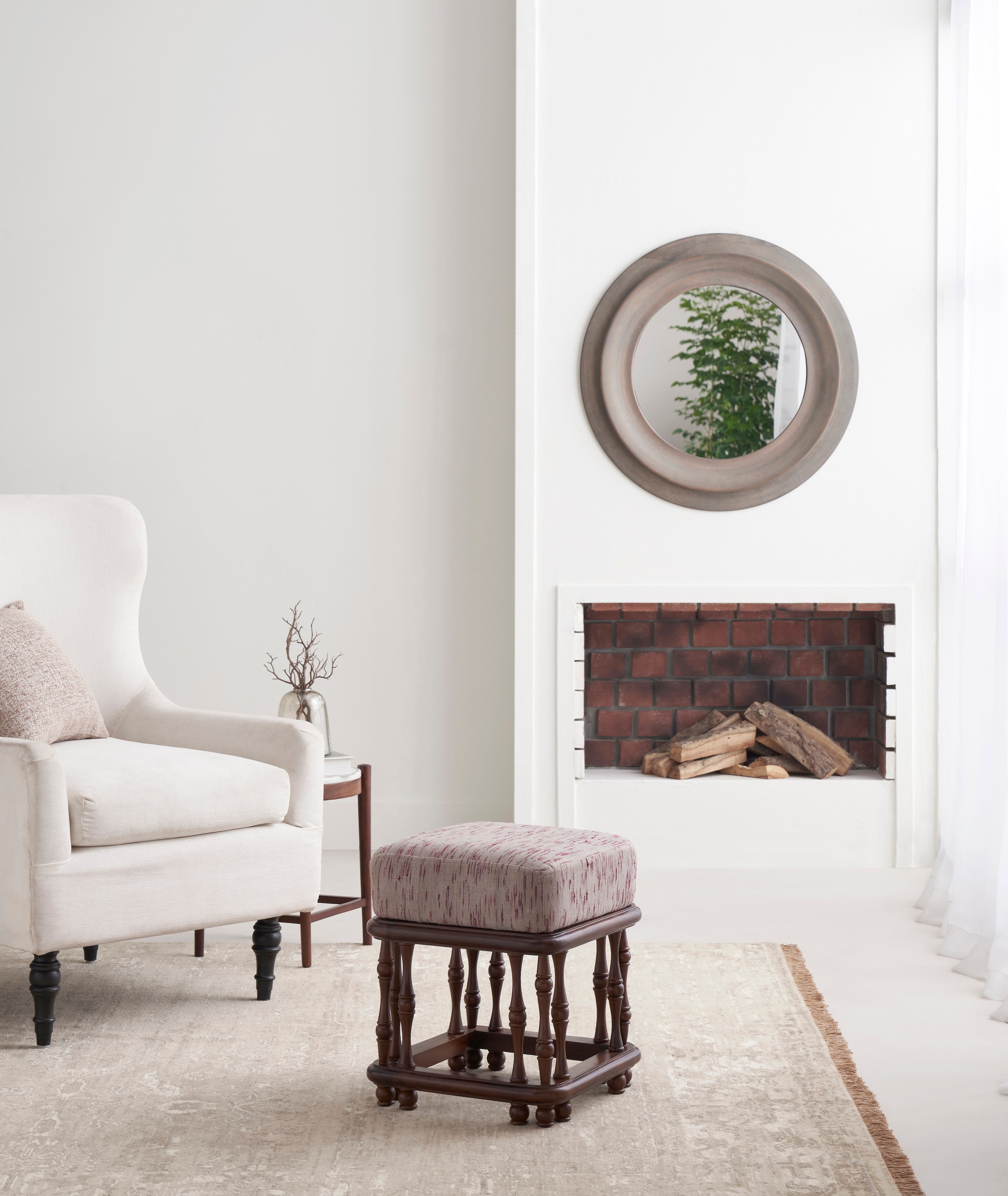 Side view of the upholstered Sheesham wood ottoman, highlighting its sturdy wooden frame and upholstered top.