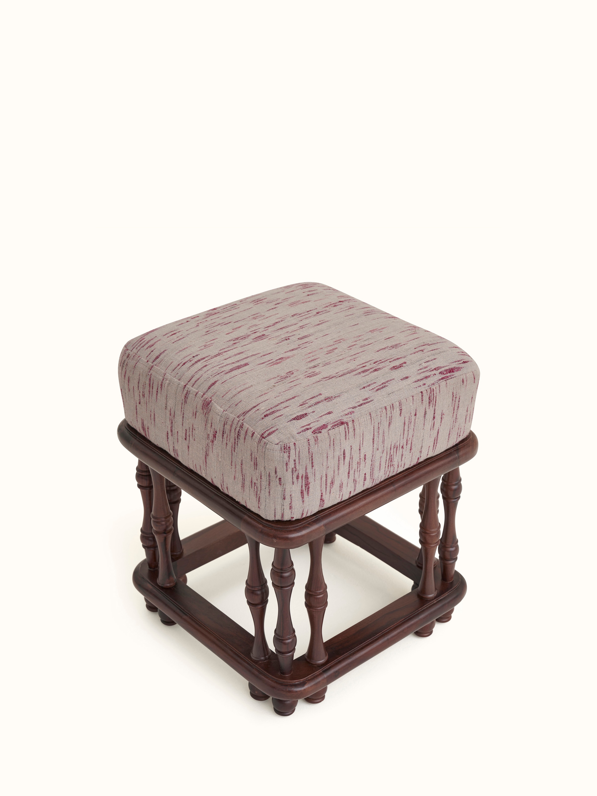 Close-up of the upholstered Sheesham wood ottoman's fabric, focusing on the texture and design details.