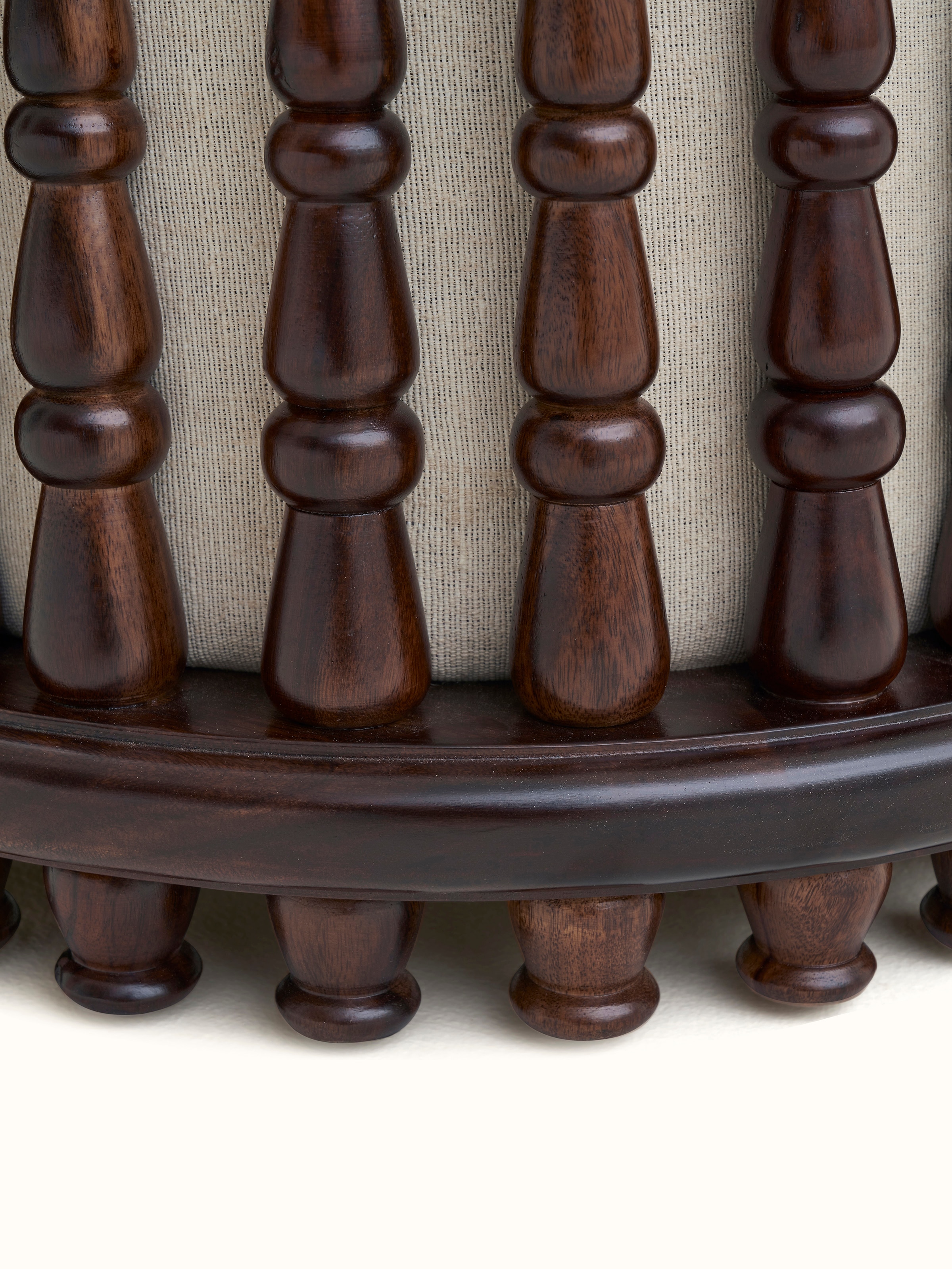 Angle view of the square pouffe with Sheesham wood base and upholstered top, highlighting its versatility and style