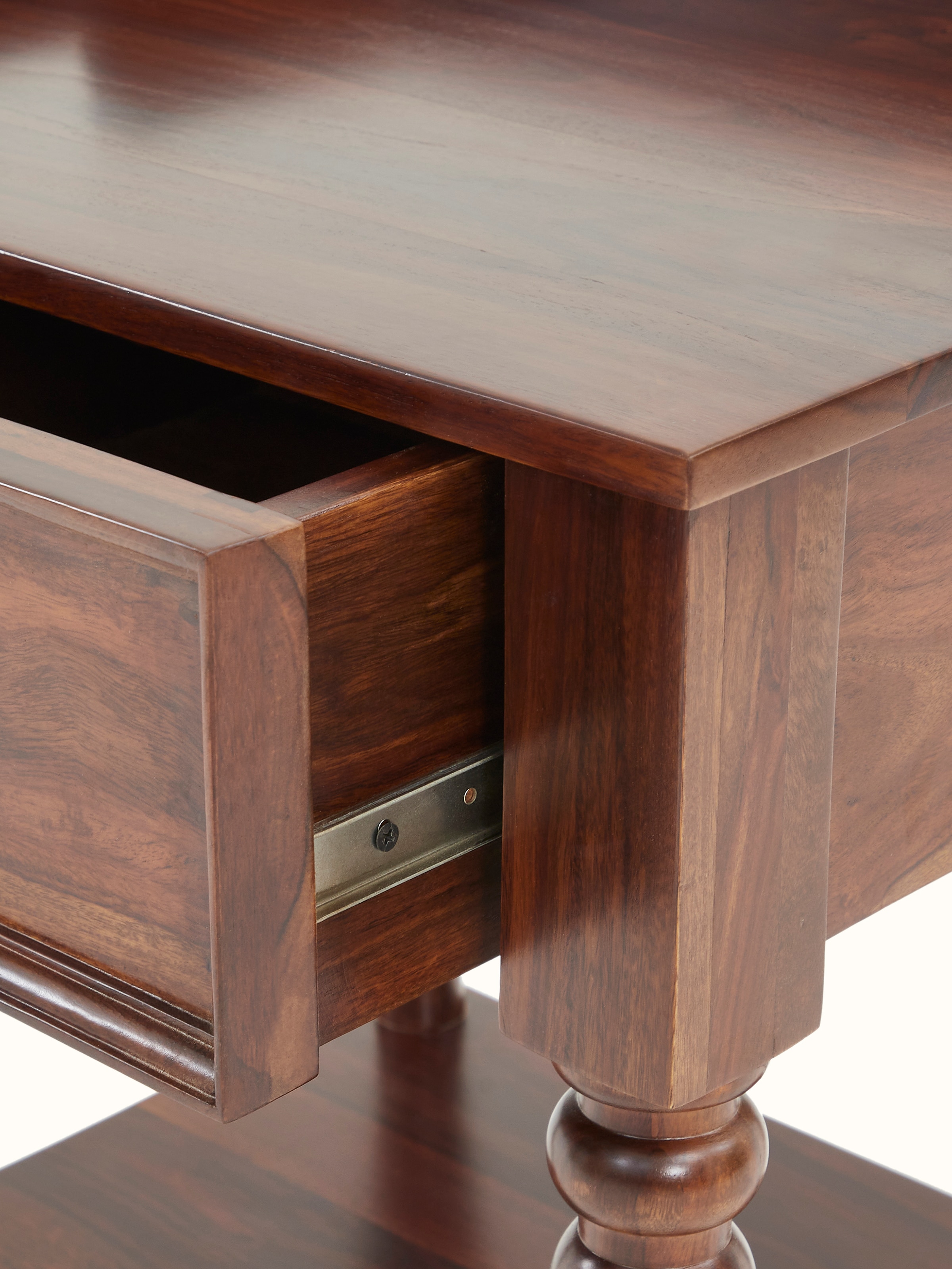 Angle view of the teak finish Sheesham wood bedside table, showing the design and sturdiness of the structure.