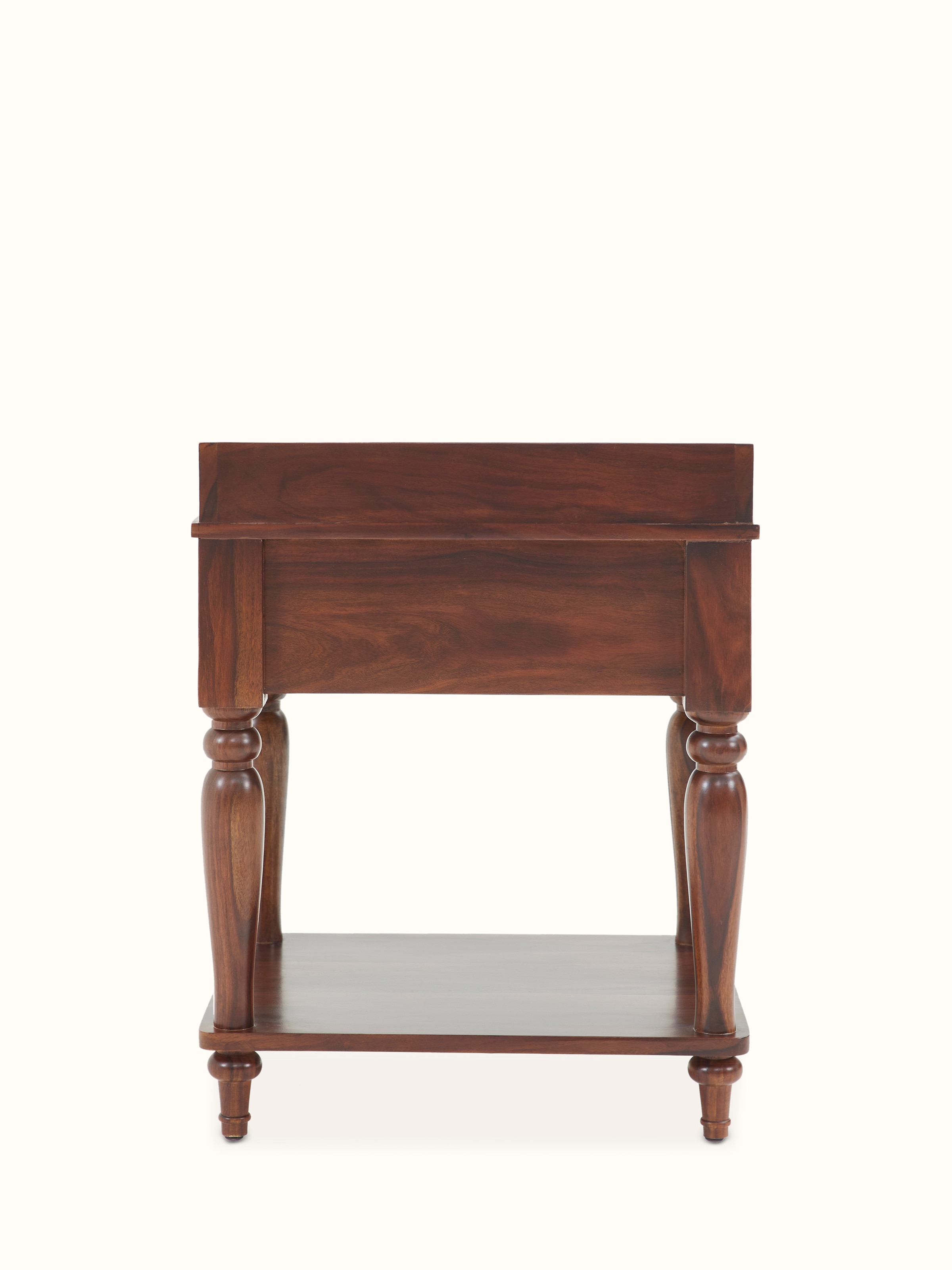 View of the teak finish Sheesham wood bedside table with focus on its base and leg design.