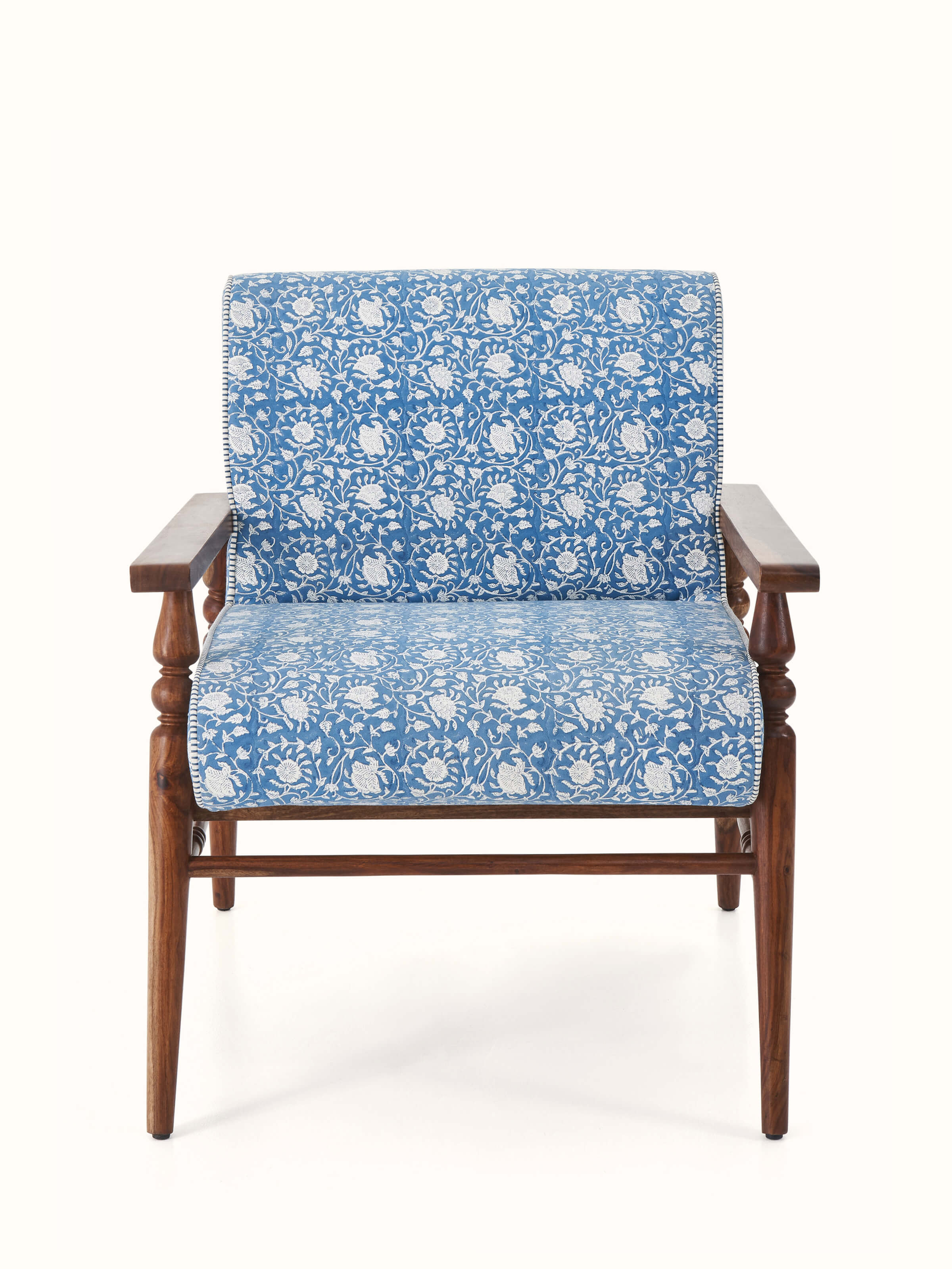 Front view of the Sheesham wood armchair with Sanganeri block print upholstery, highlighting the detailed fabric design.
