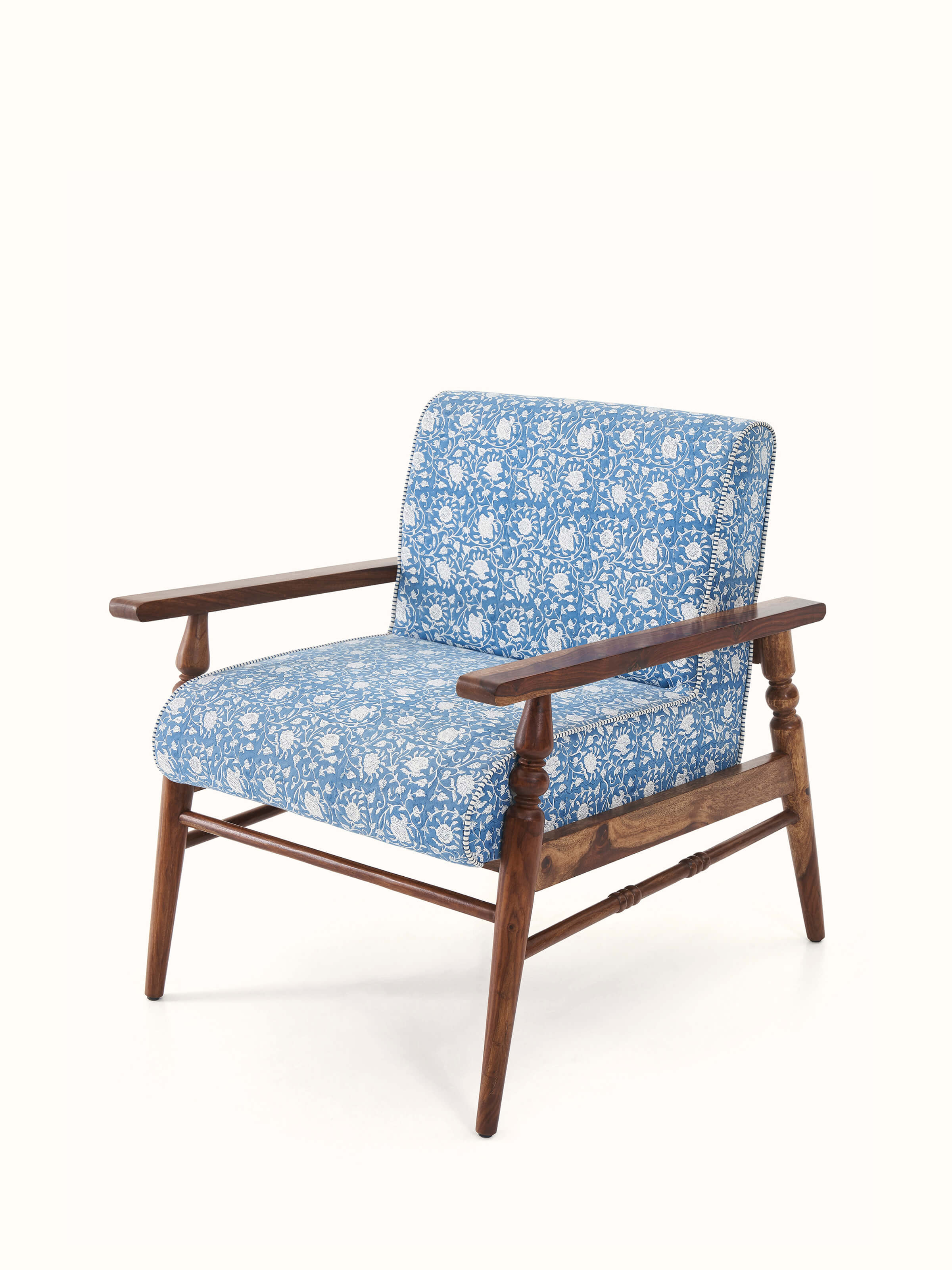 Close-up of the Sanganeri block print fabric on the Sheesham wood armchair, emphasizing the intricate patterns and colors.