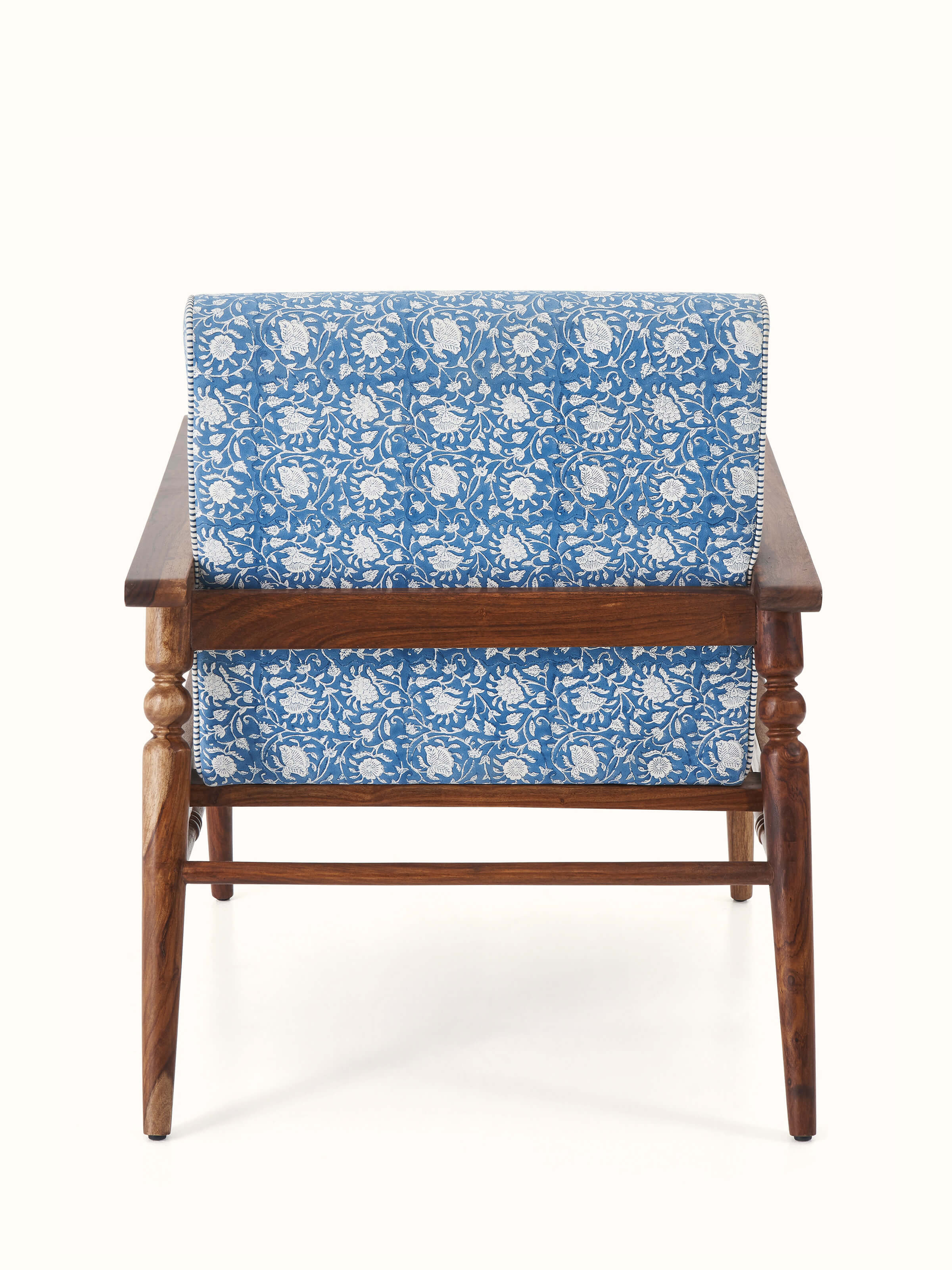 Close-up of the armrest and seat cushion of the Sheesham wood Sanganeri block print armchair, focusing on the comfort and craftsmanship.