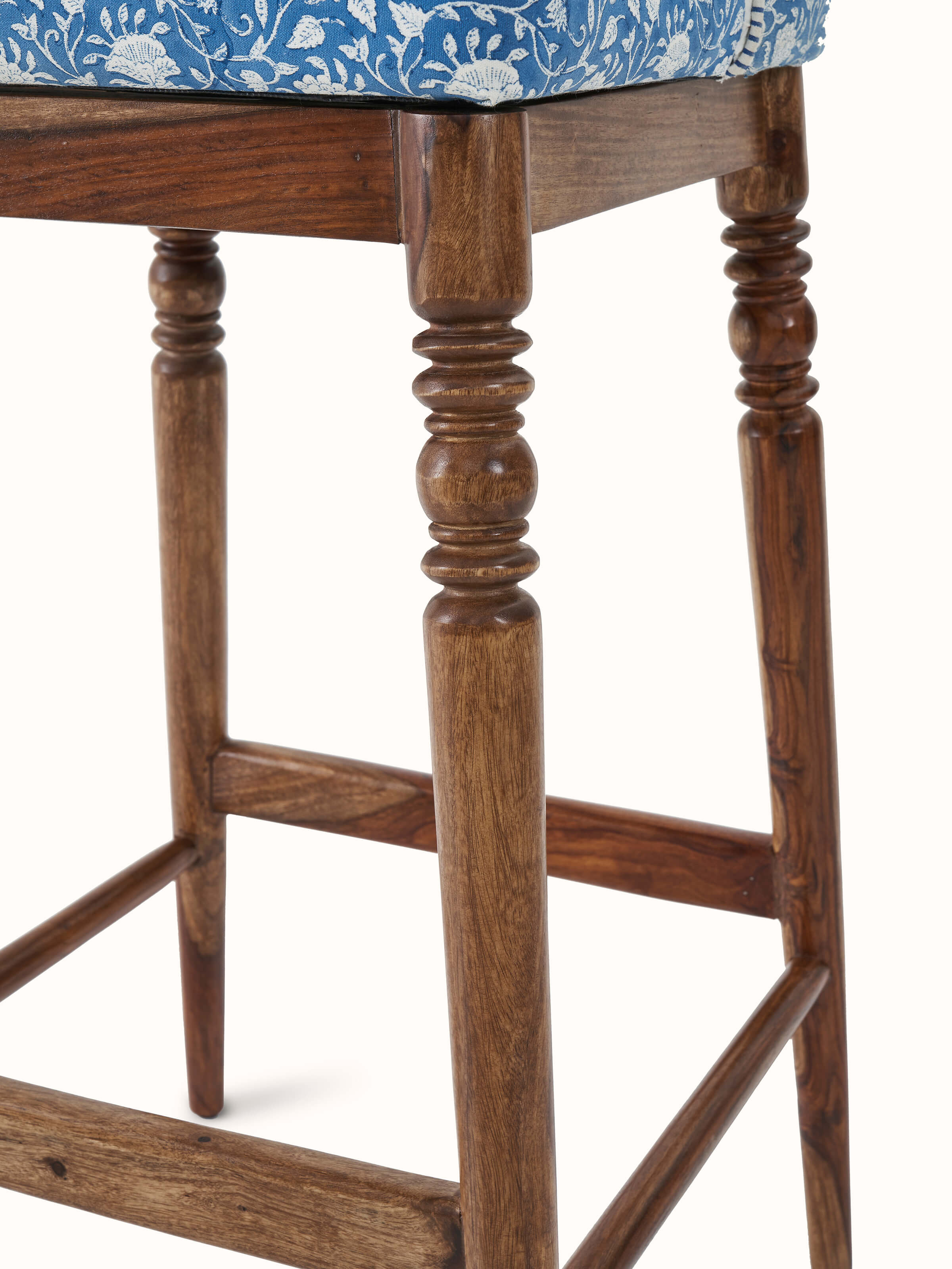 Detailed image of Sheesham wood Sanganeri block print bar chair’s backrest with traditional block print and wood finish