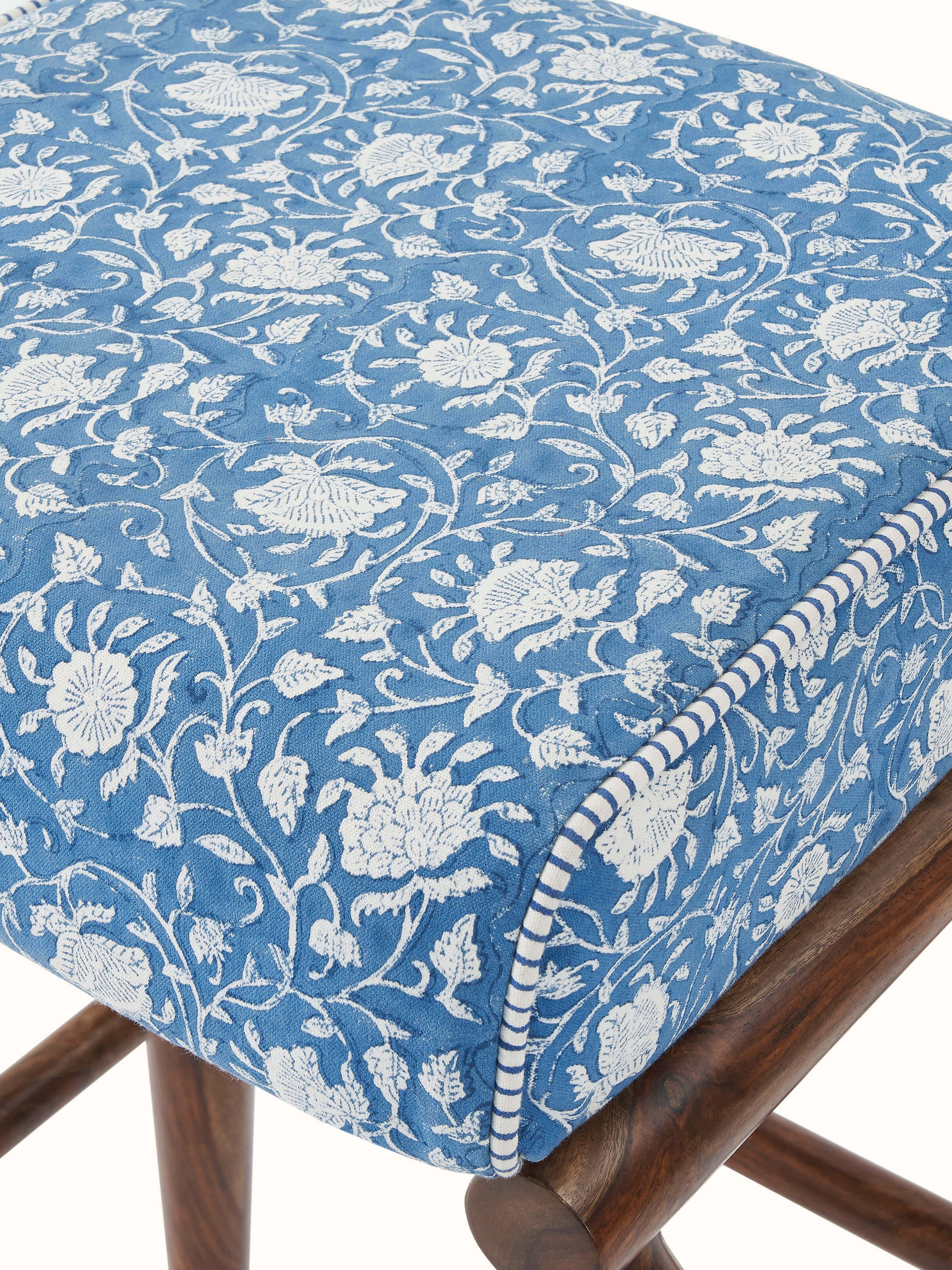 Angle view of the Sheesham wood Sanganeri block print square seat bar stool, showing the design of the legs and seat pattern.