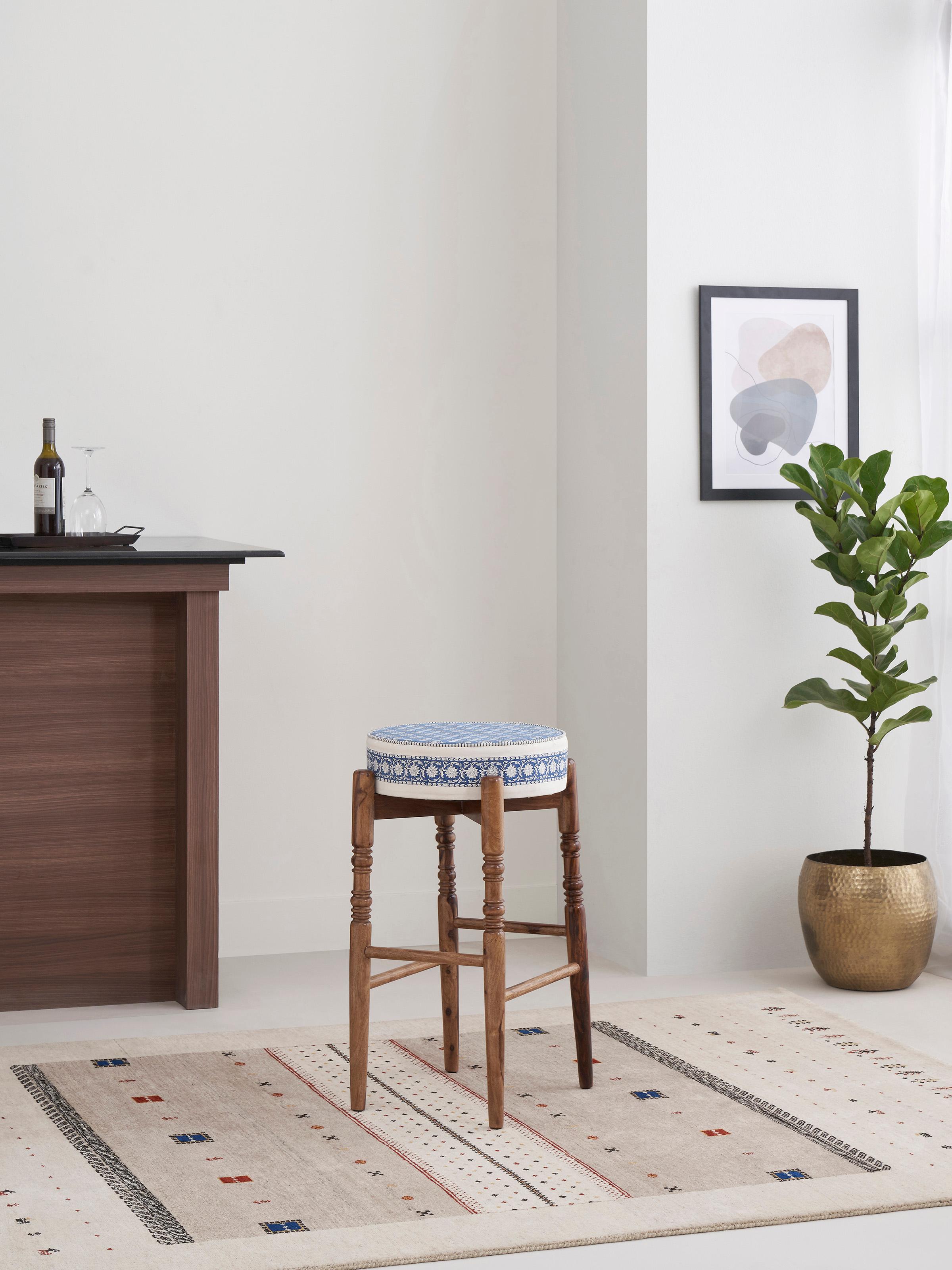 Side view of Sheesham wood bar stool with Sanganeri block print seat, highlighting the round design and detailed print.