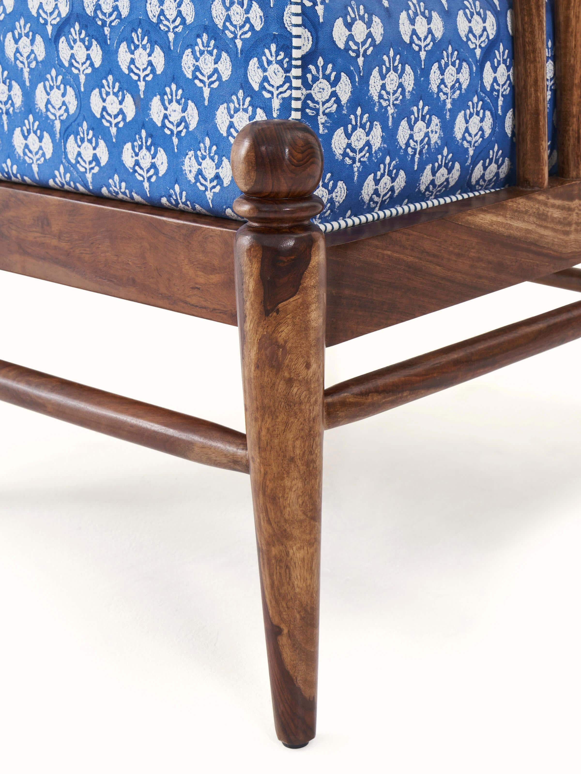 Base view of Upholstered Sheesham Wood Sanganeri Block Print Lounge Chair showcasing sturdy wood legs and quality craftsmanship.