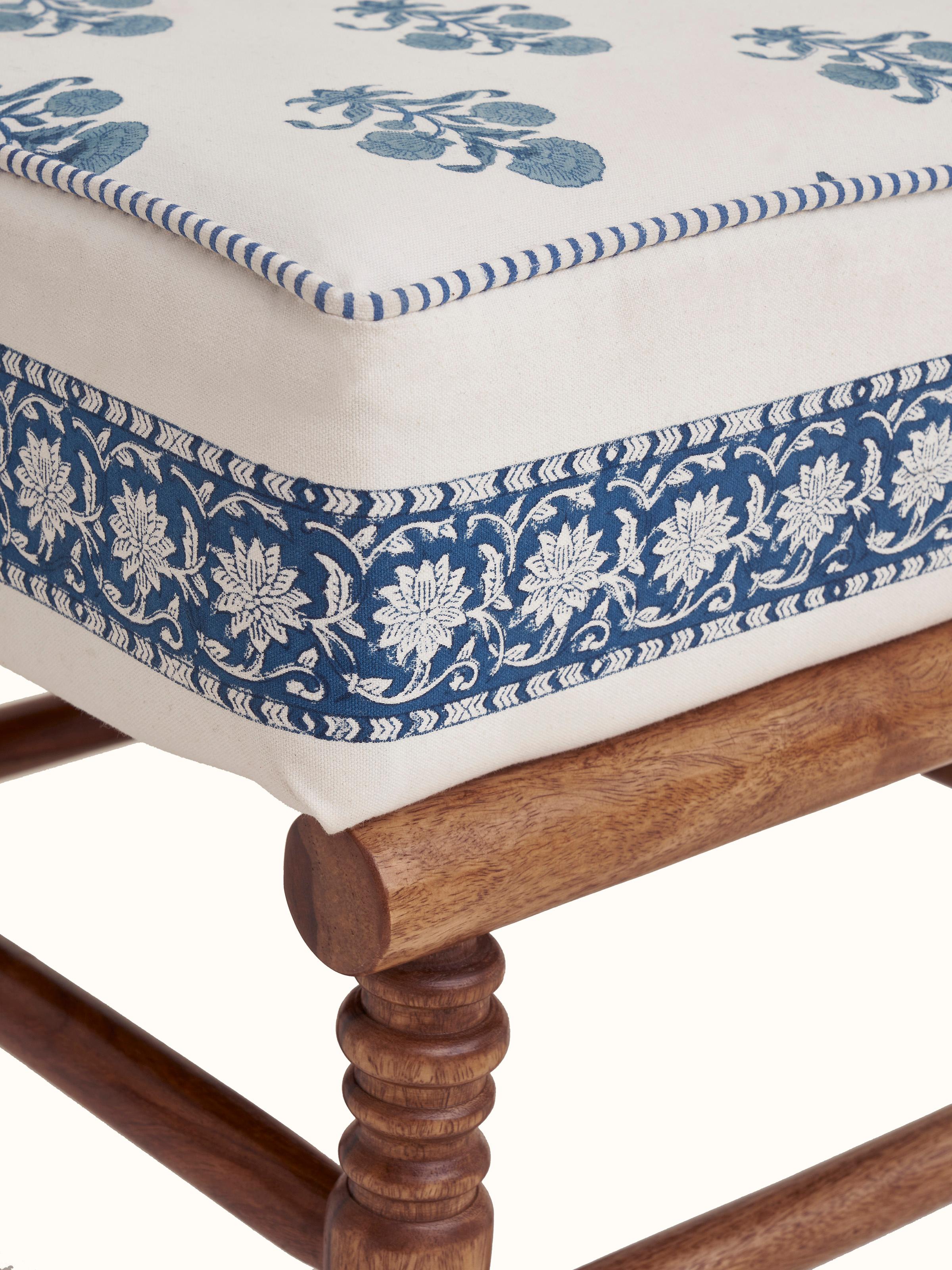 Rear view of the Sheesham wood Sanganeri block print ottoman, displaying the robust wooden structure and elegant upholstery