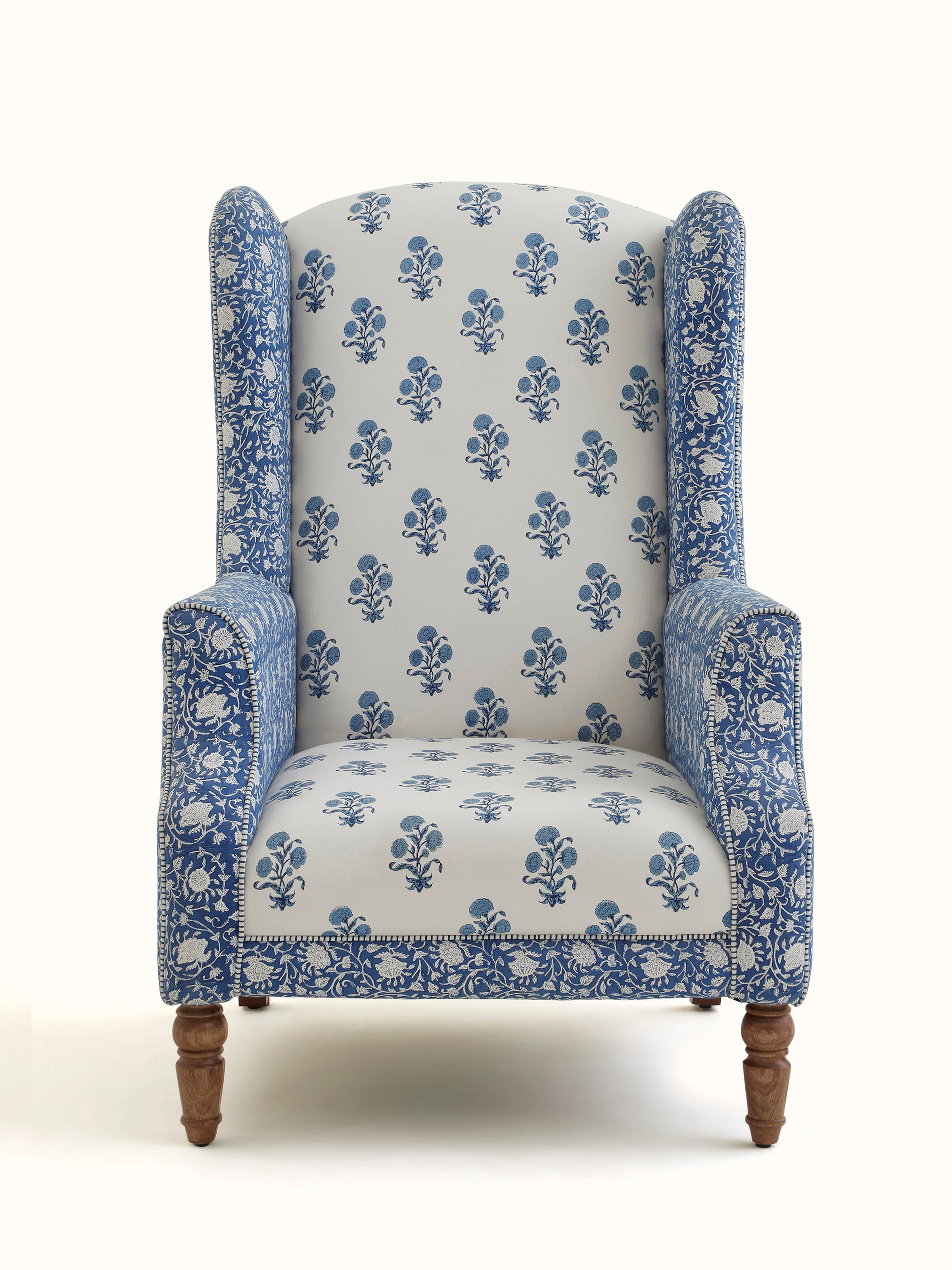 Front view of the upholstered Sheesham wood Sanganeri block print high back wing chair, showcasing the intricate block print design and high back