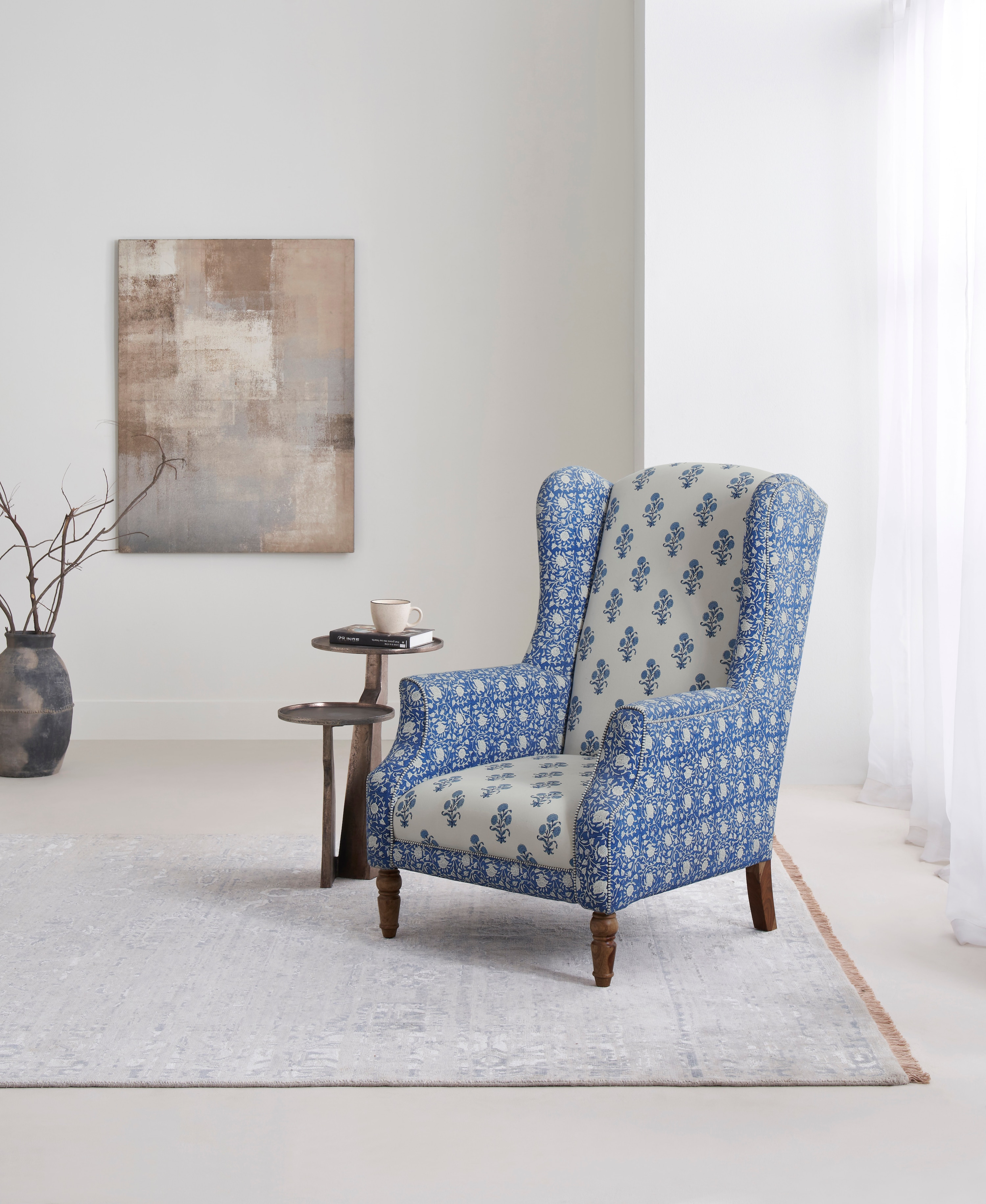 Side view of the Sheesham wood Sanganeri block print wing chair, highlighting the block print upholstery and elegant wing design