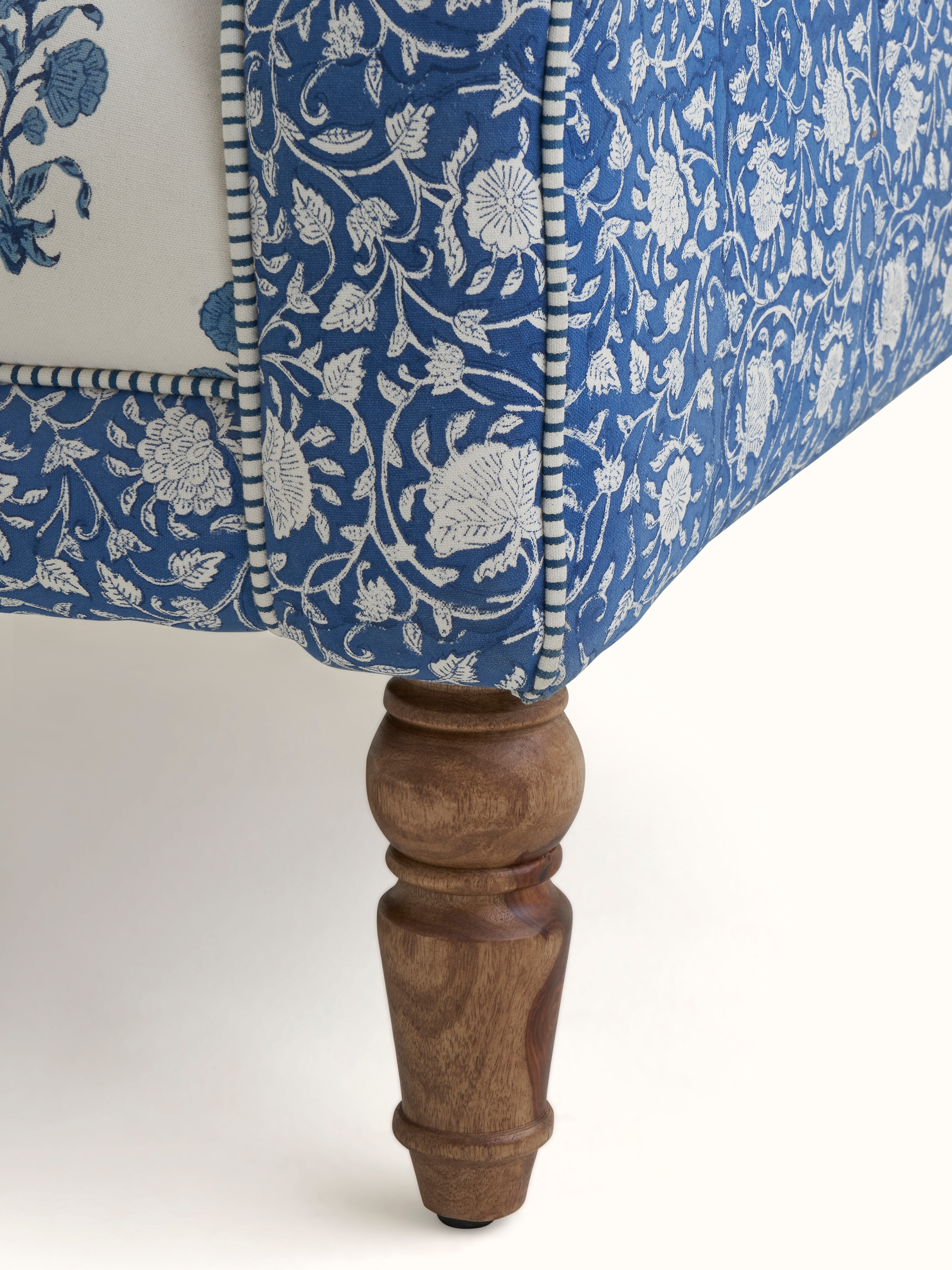 Angled view of the high back wing chair in a room setting, demonstrating its use and design as part of interior decor