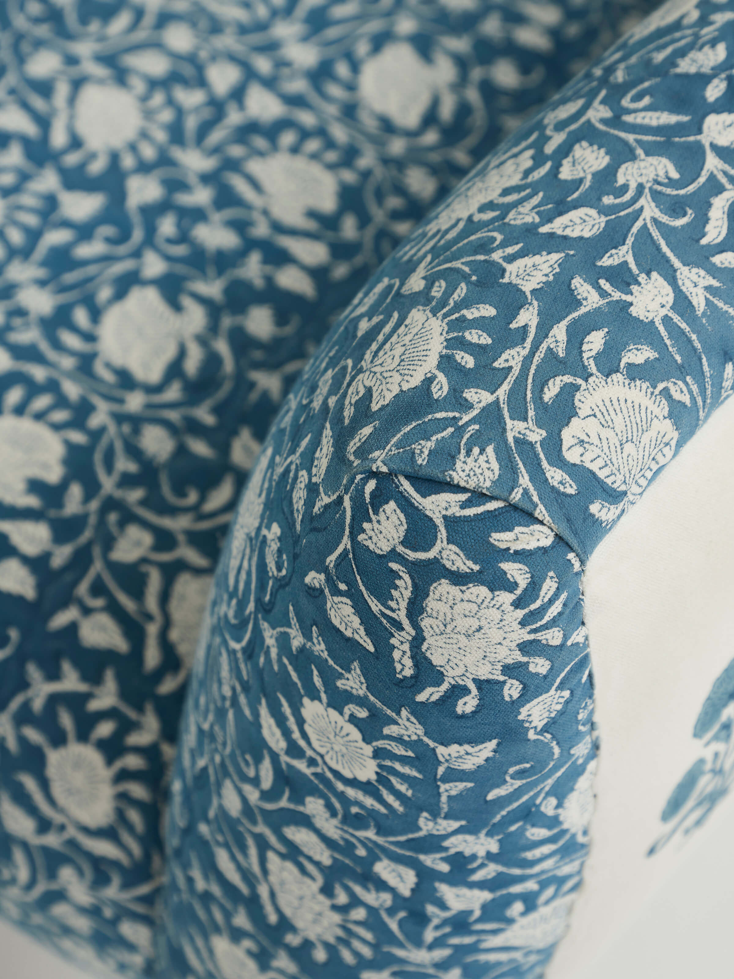 Close-up of the wing and armrest of Upholstered Sheesham Wood Sanganeri Block Print Wing Chair, highlighting craftsmanship and upholstery