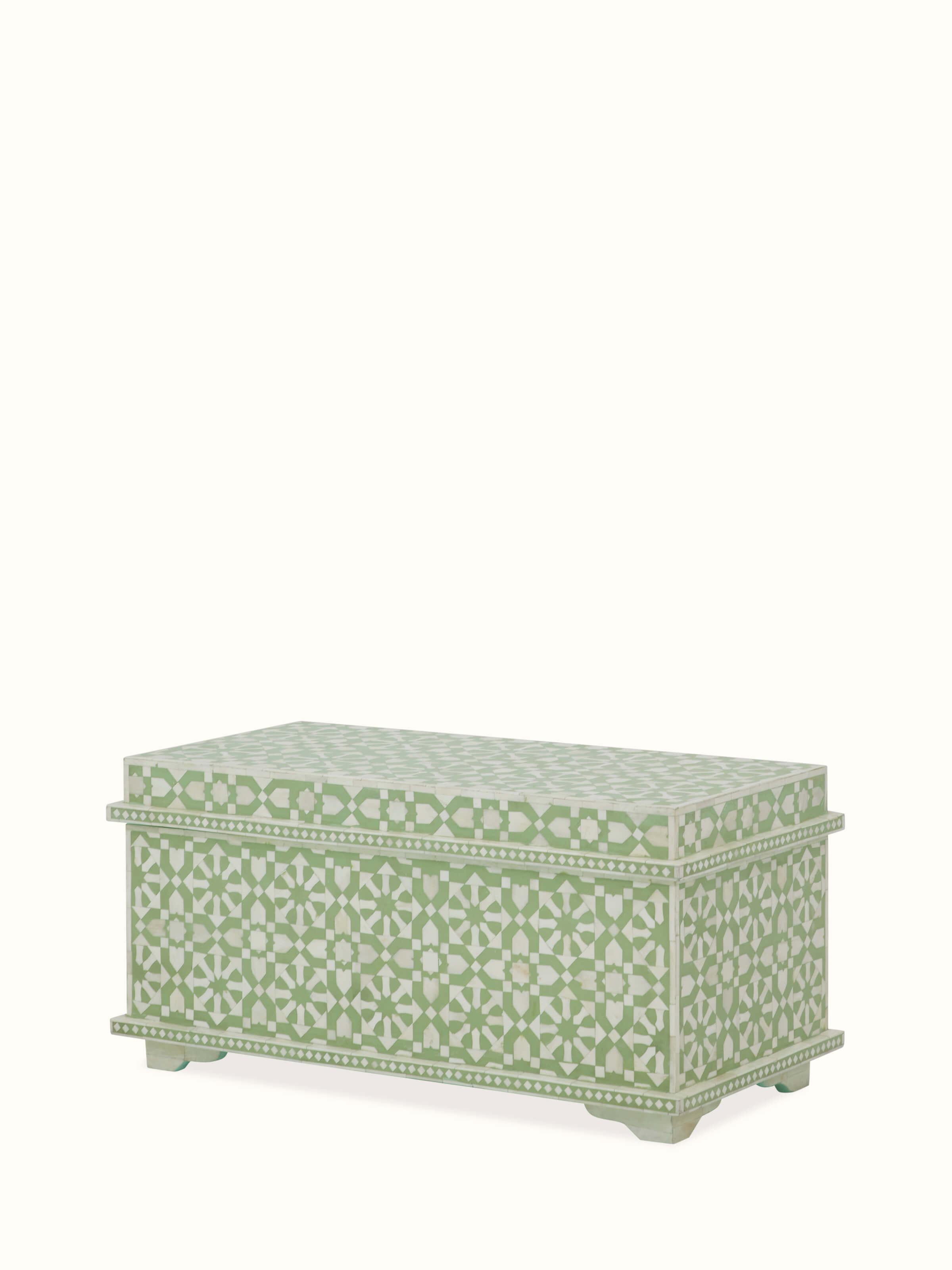 Angled view of the bone inlaid trunk, emphasizing the ornate inlay work and classic design