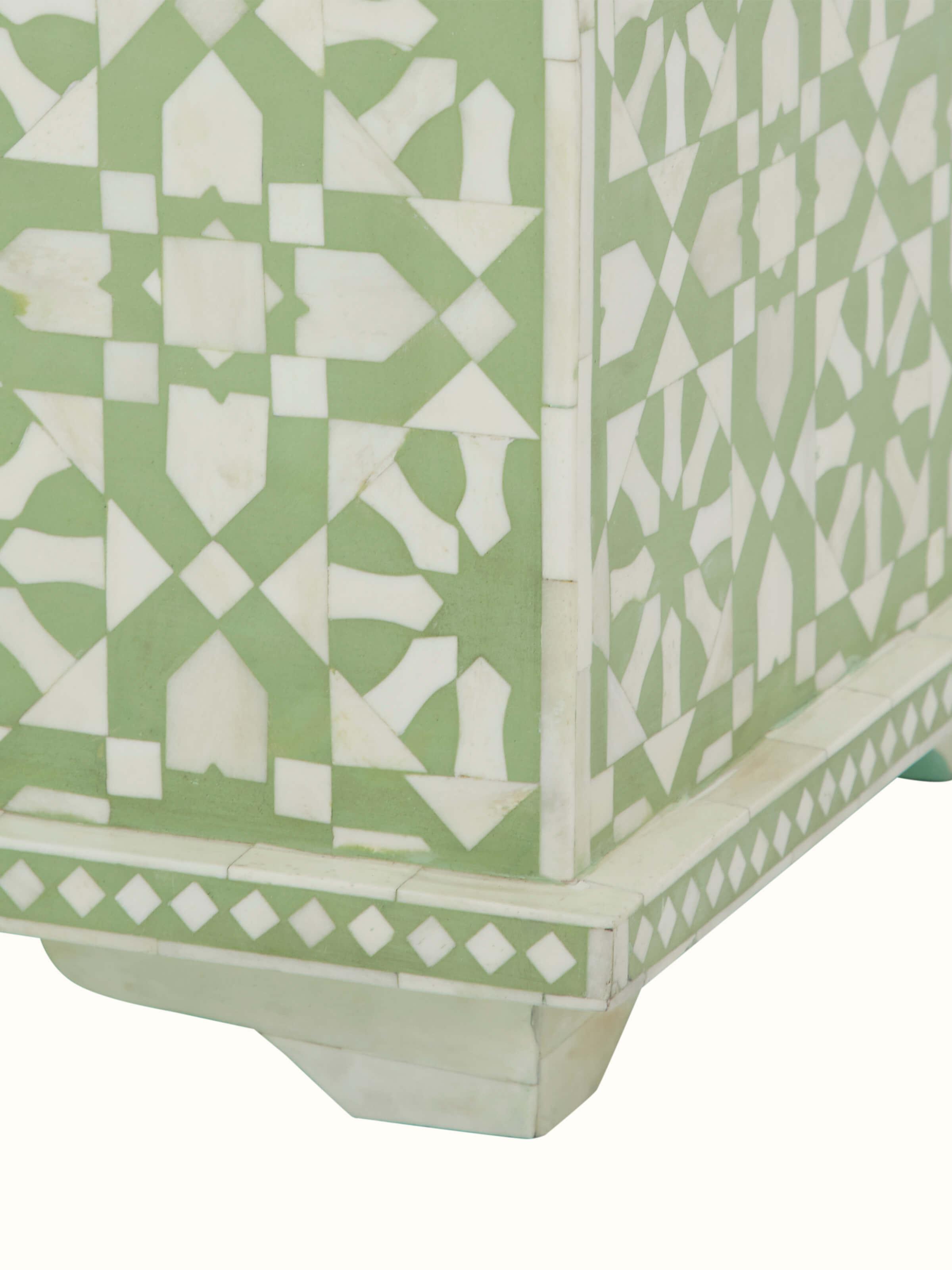 Close-up of the bone inlaid trunk, capturing the fine details of the bone inlay and the trunk's craftsmanship