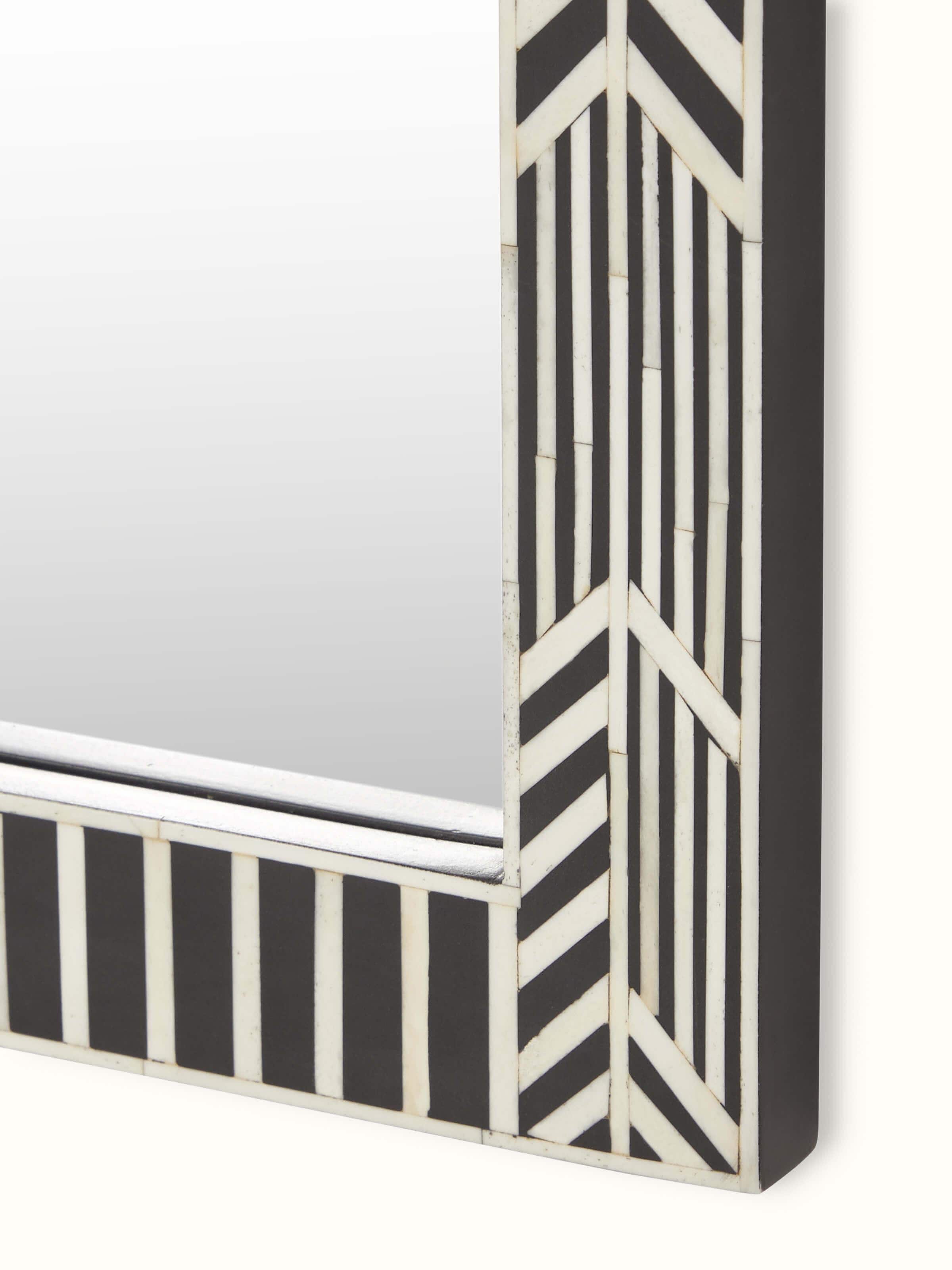 Angled view of the bone inlaid rectangular wall mirror, highlighting the depth and texture of the inlaid design